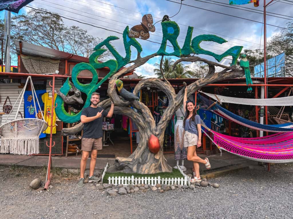 two people in front of costa rica sign