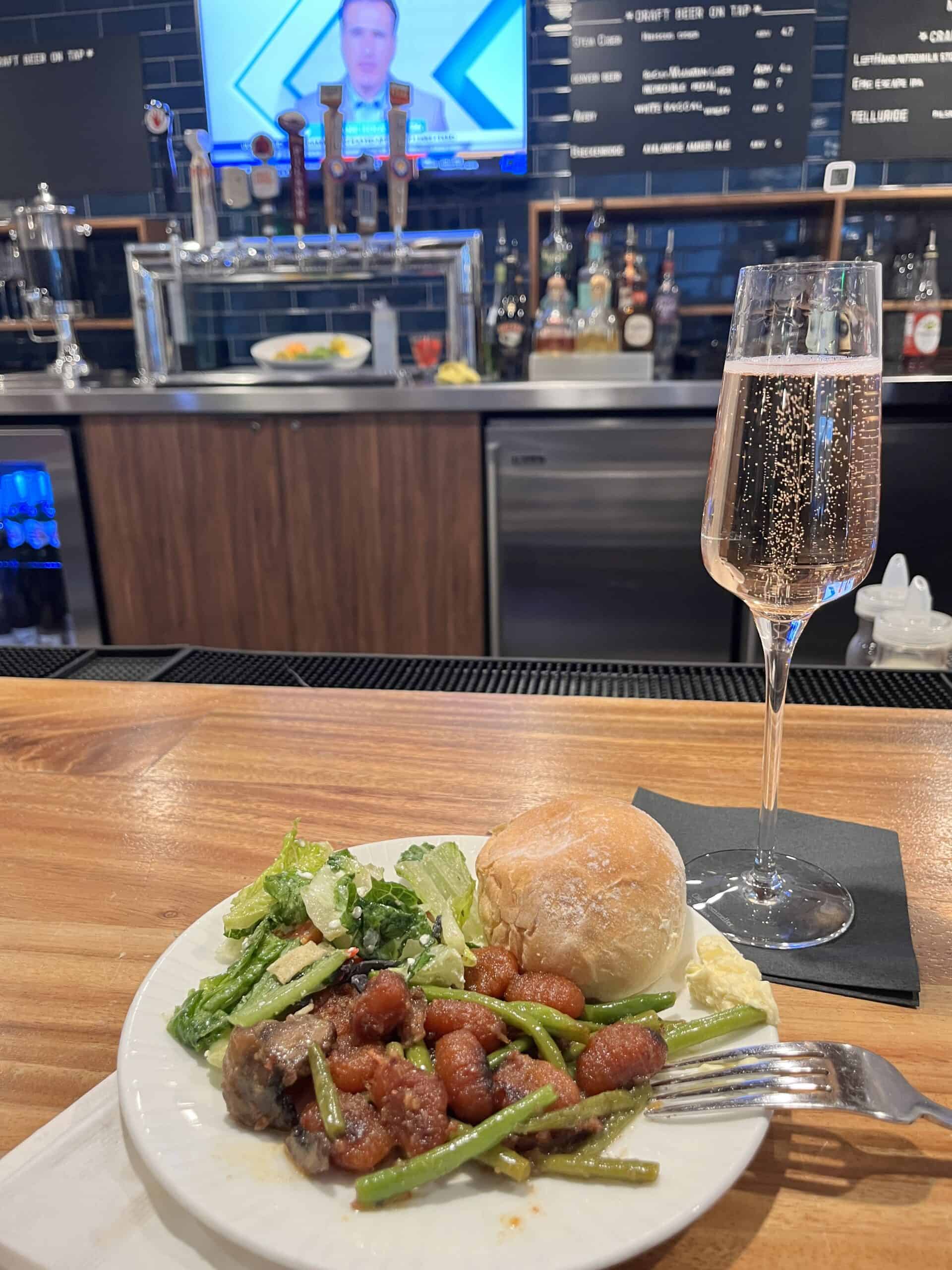 gnocchi and champagne in the centurion lounge