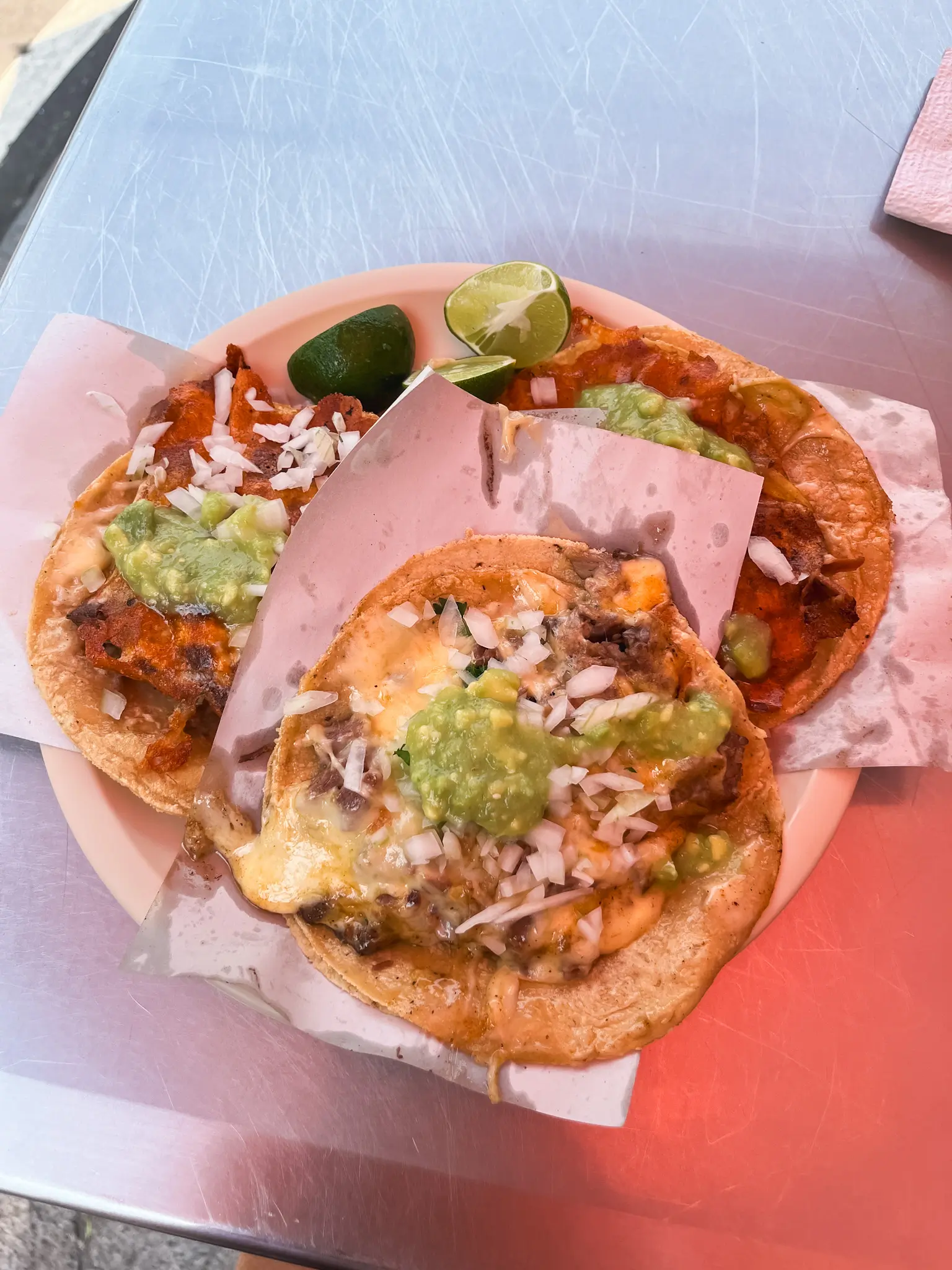 three tacos on a plate in a mexico city food tour