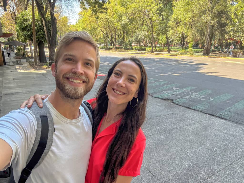 man in white shirt and woman in red top by parque españa for where to stay in mexico city