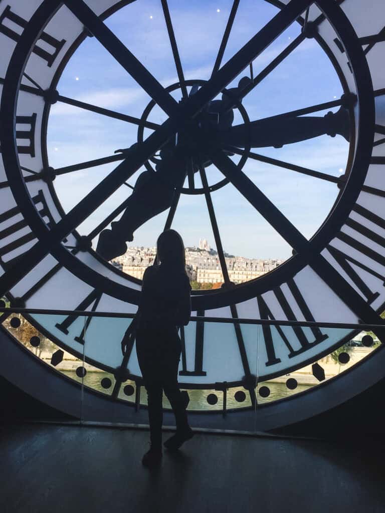 Catch breathtaking views through the famous Musée d'Orsay clock — one of the best hidden gems to experience during your one day in Paris