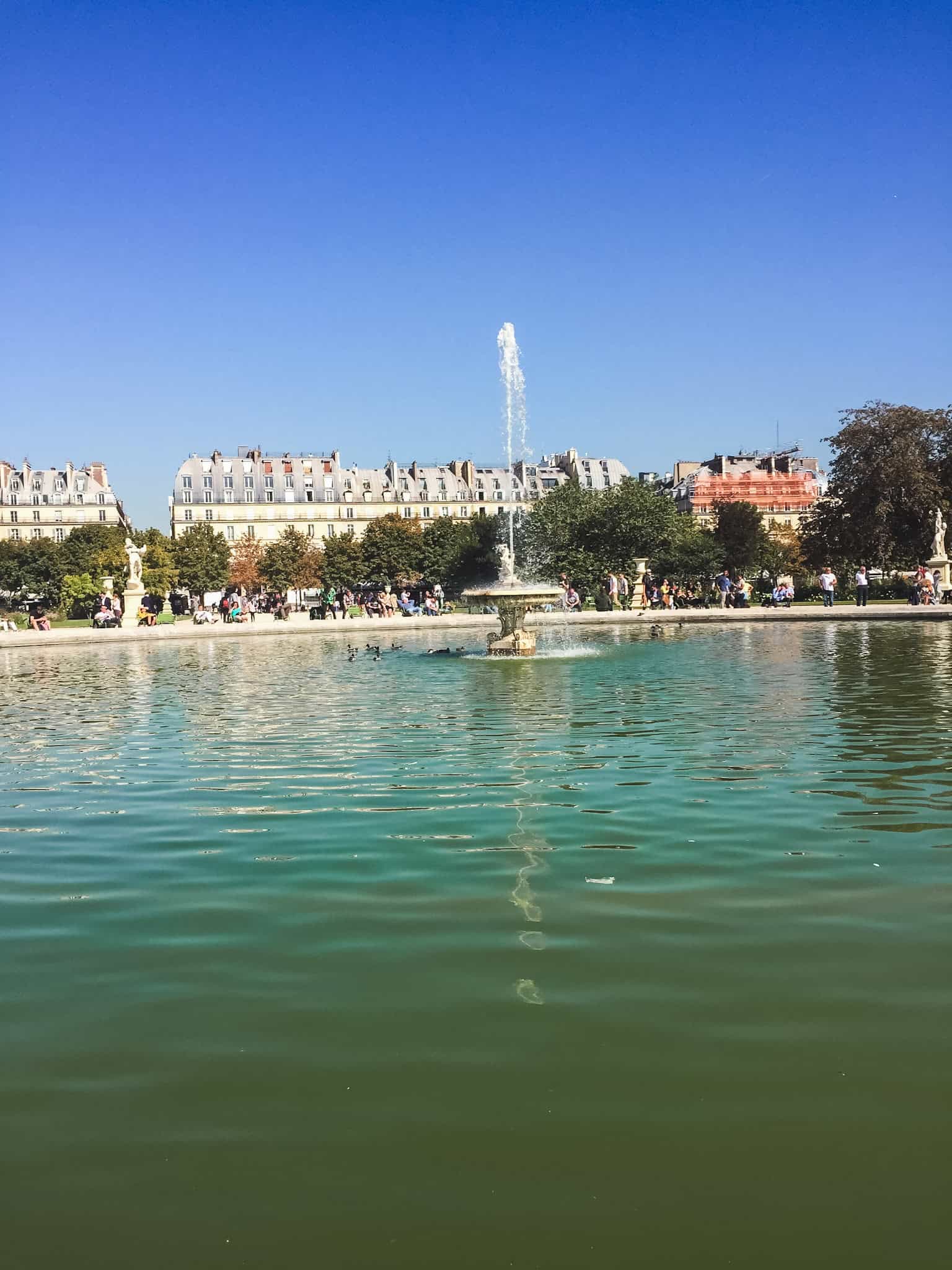 Relax by the fountains at the Tuileries Gardens, one of the prettiest places to unwind after sightseeing all day in Paris.