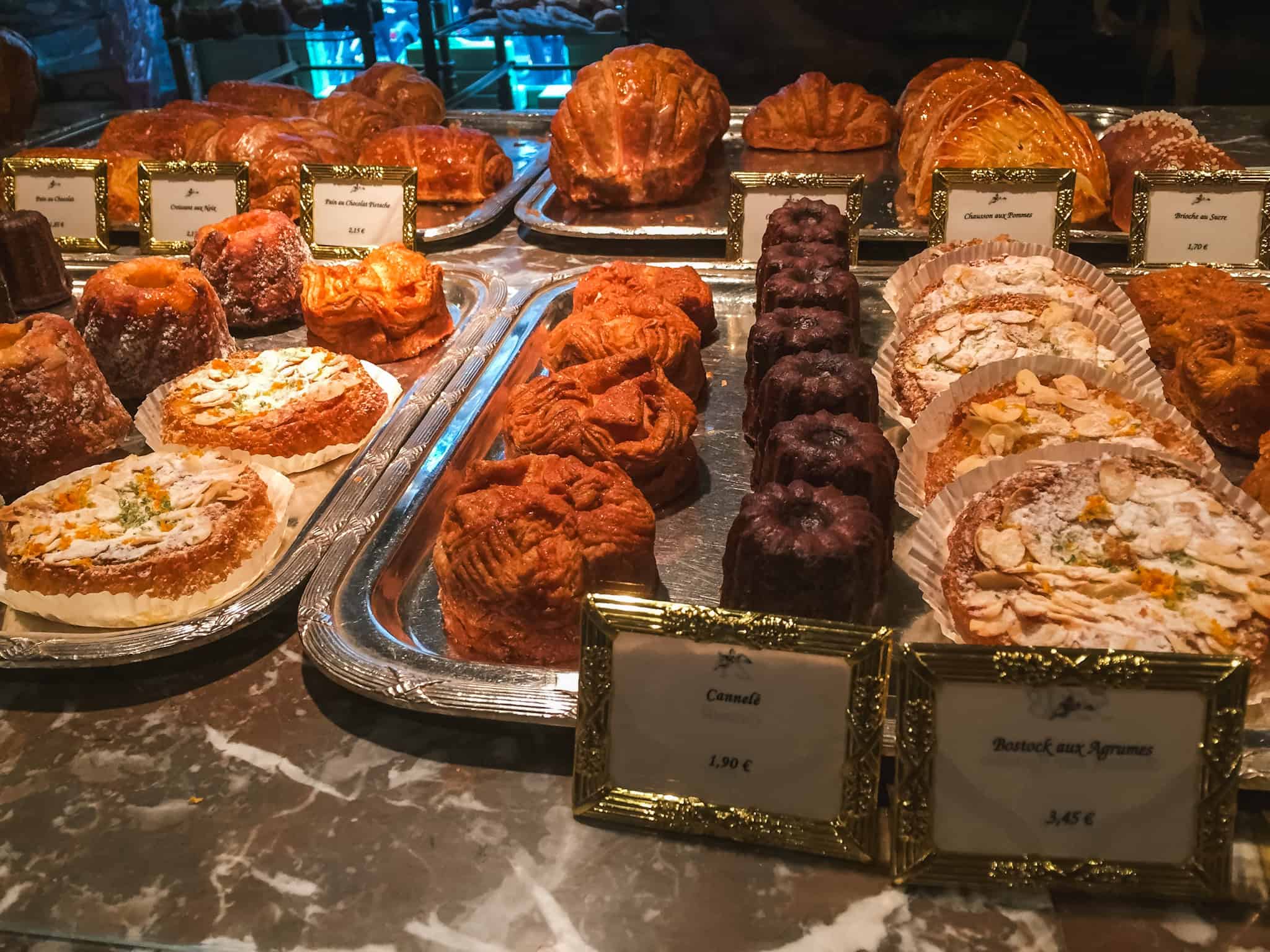 Golden croissants, cannelés, and seasonal pastries at a boulangerie, one of the joys of Paris in winter.