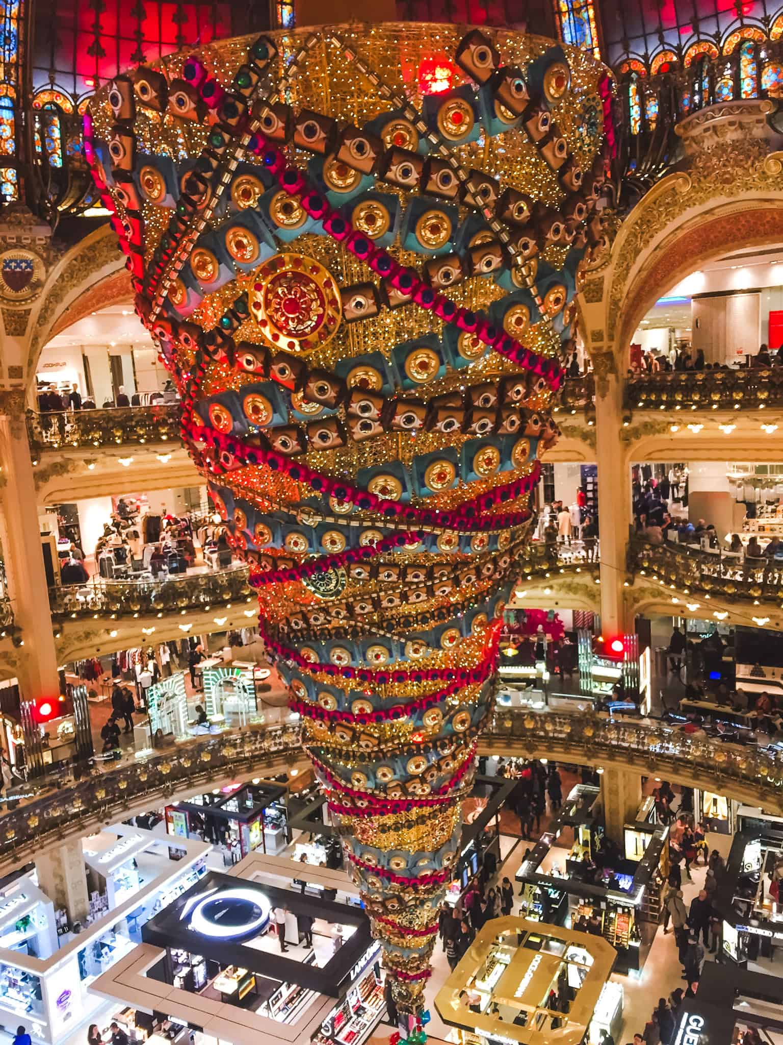Massive upside-down Christmas tree at Galeries Lafayette, decked in festive lights during Paris in winter.