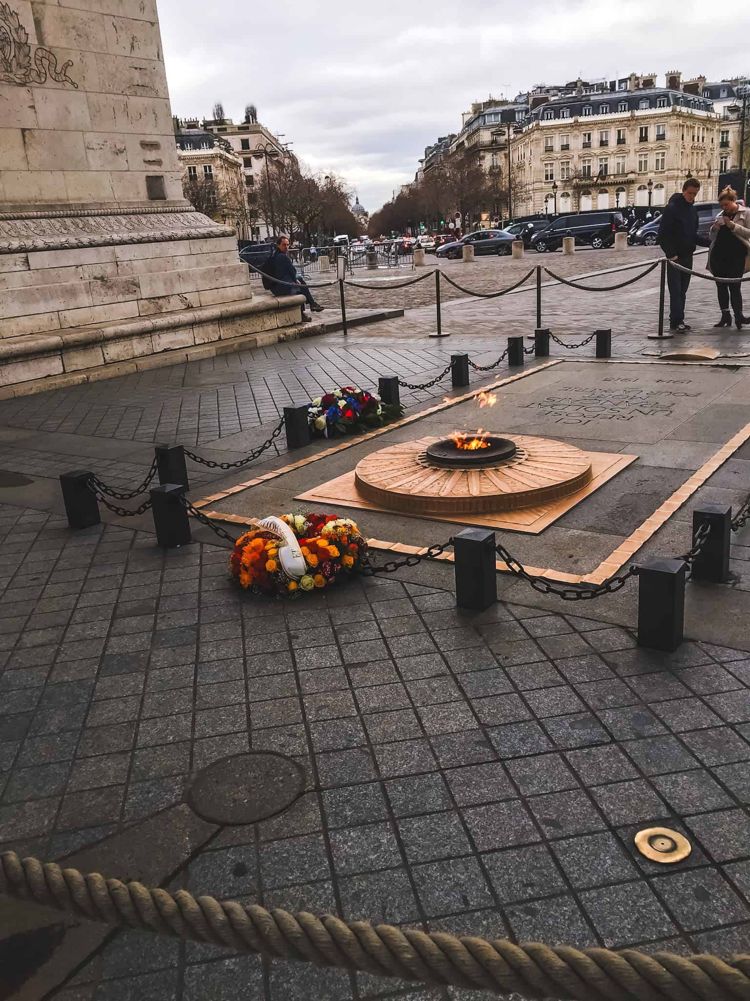 Eternal flame at the Tomb of the Unknown Soldier beneath the Arc de Triomphe, a solemn historical stop in Paris.