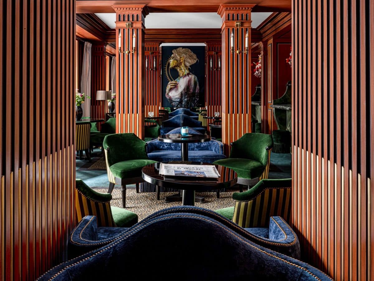 lush greed and blue chairs in the lobby of the chambre du marais hotel 