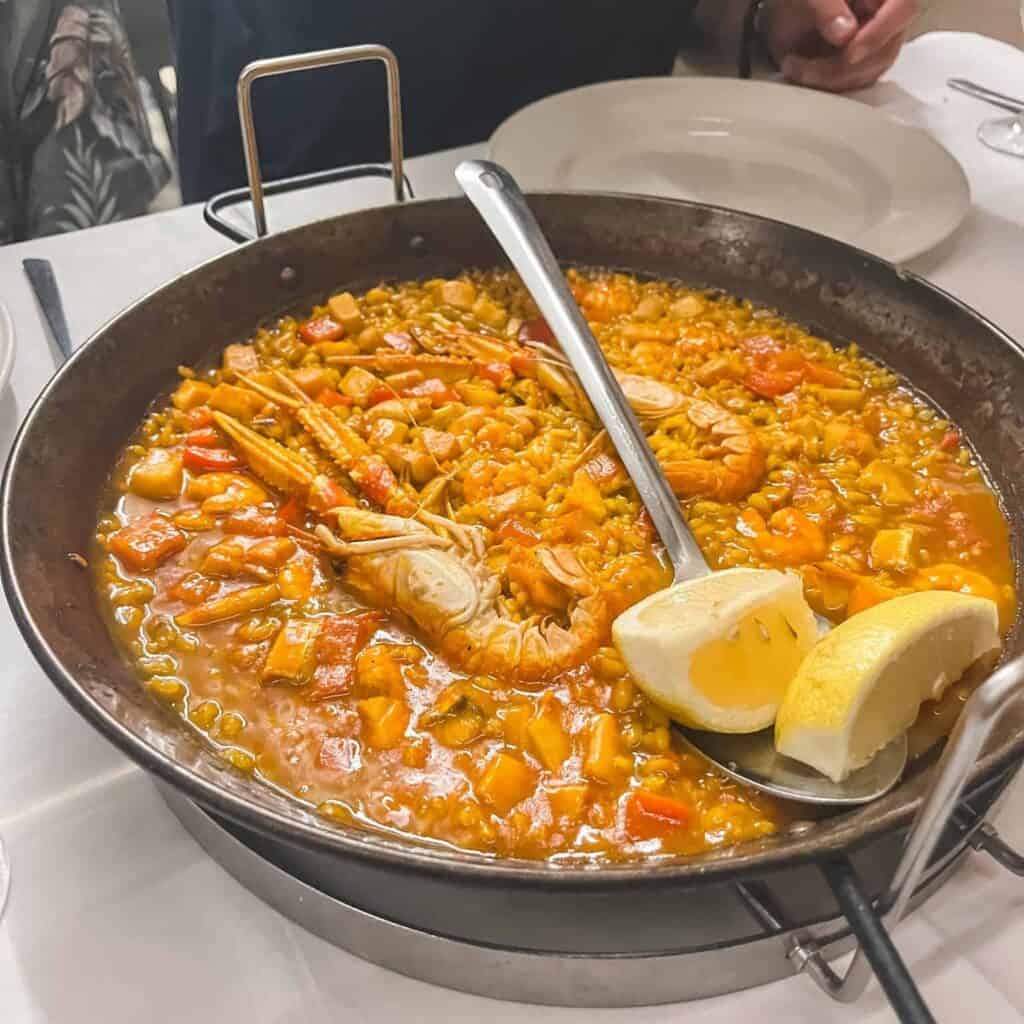 Traditional seafood paella with prawns and mussels served in authentic paellera - perfect dish to try during 3 days in Malaga