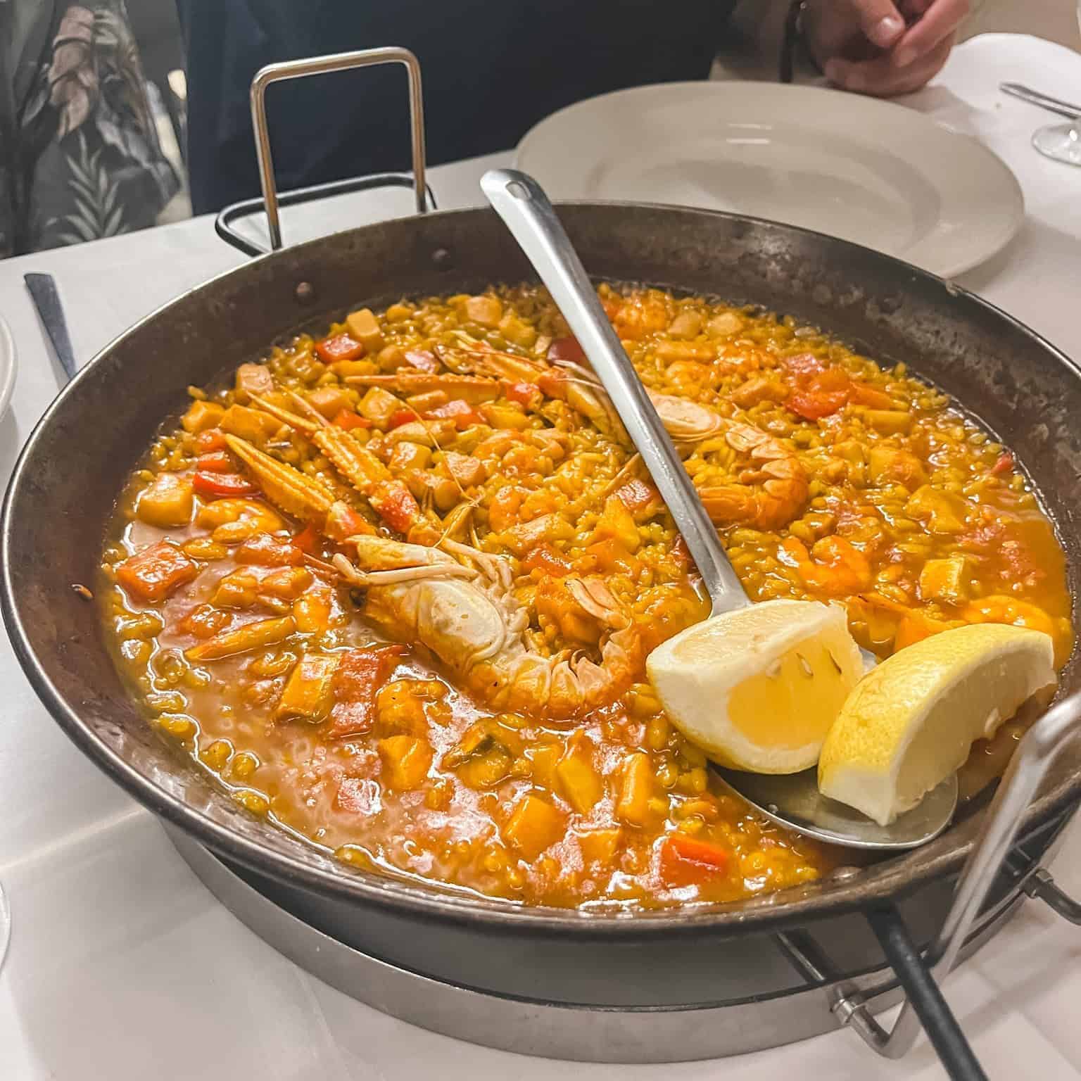Traditional seafood paella with prawns and mussels served in authentic paellera - perfect dish to try during 3 days in Malaga