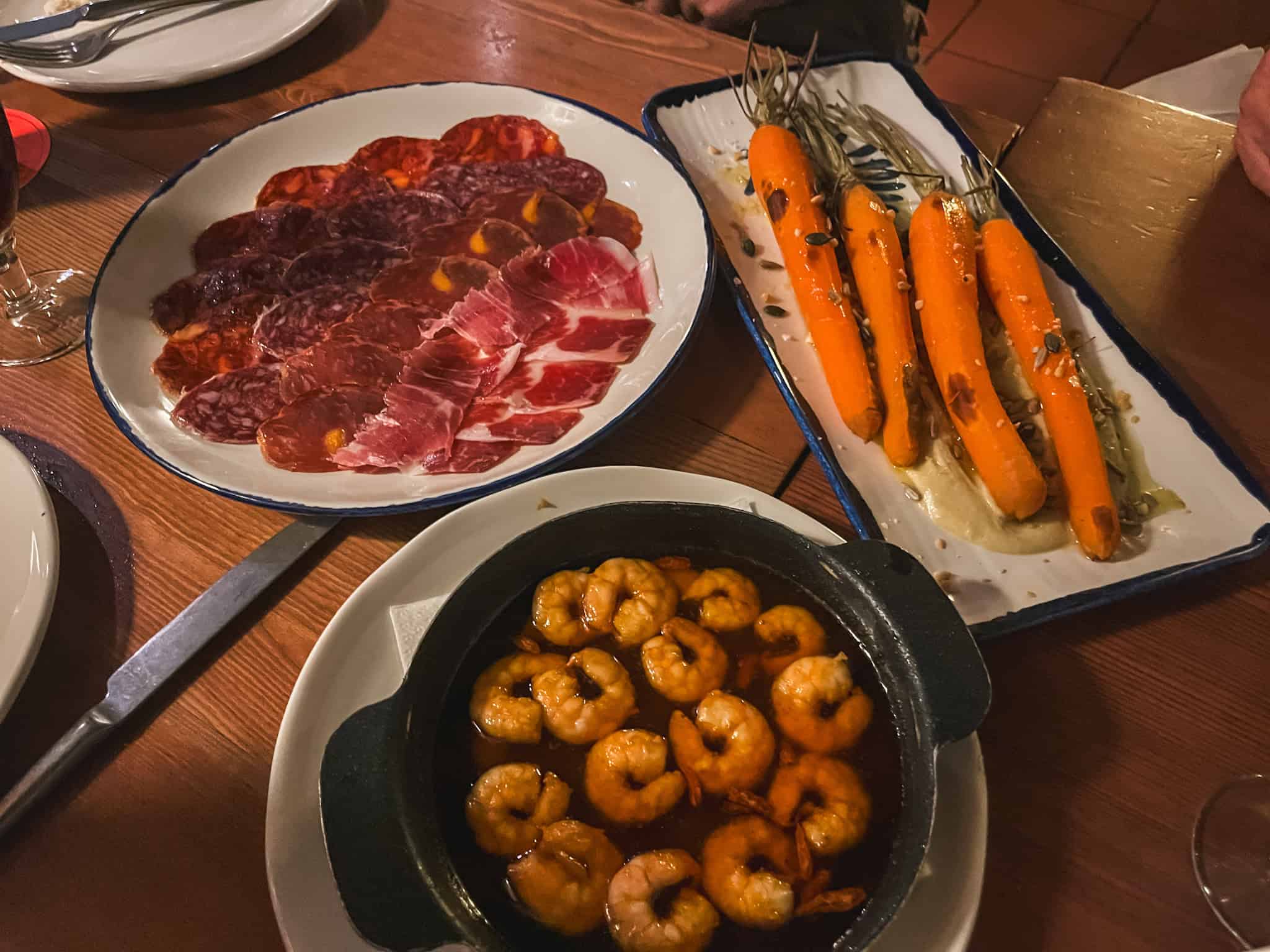 panish tapas spread featuring charcuterie board and gambas al ajillo - essential food experiences for 3 days in Malaga
