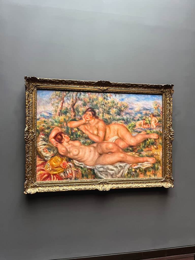 Renoir impressionist painting of nude bathers displayed in ornate gold frame - museum pass in paris includes access to world-class art collections