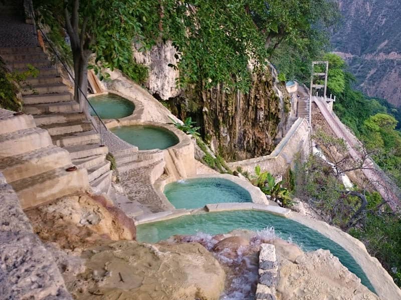 Stone walkways and terraced hot spring pools showing the developed infrastructure at Tolantongo caves