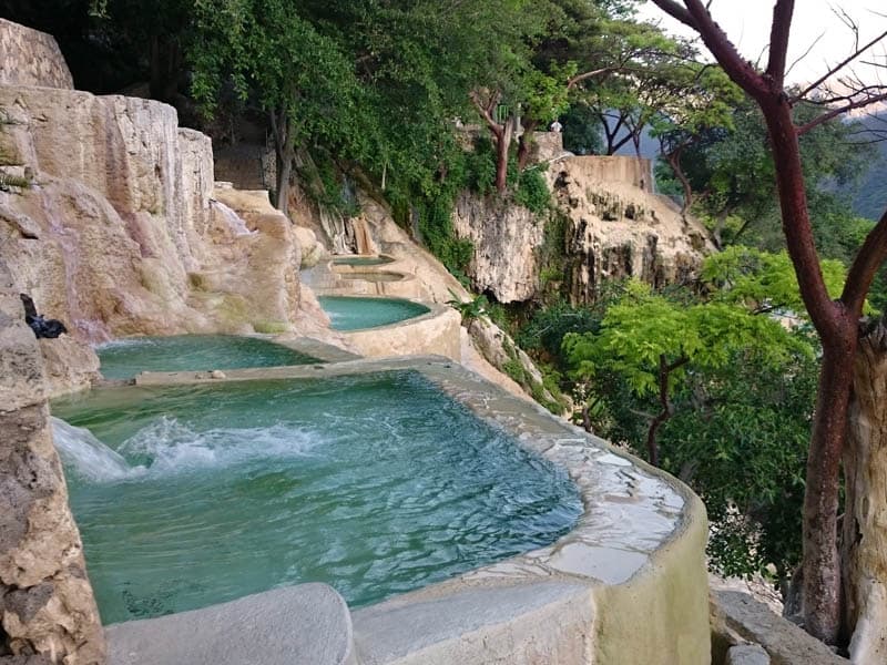 Grutas de Tolantongo infinity-style thermal pools cascading down the cliff face with mountain views