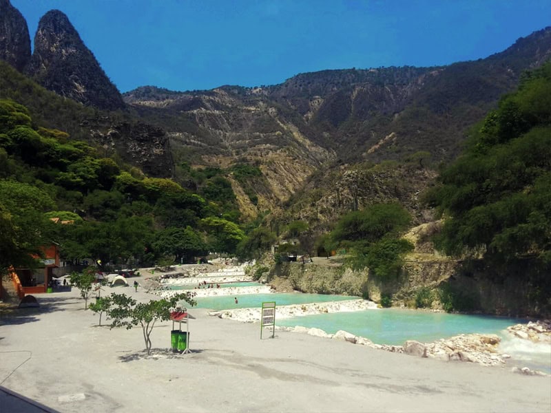 Aerial view of Grutas de Tolantongo showing the famous infinity pools, canyon setting, and thermal springs complex