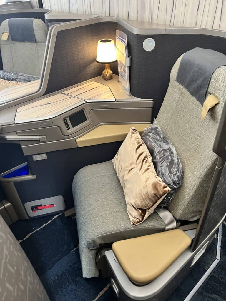 China Airlines business class seat in upright position showing workspace area and amenities