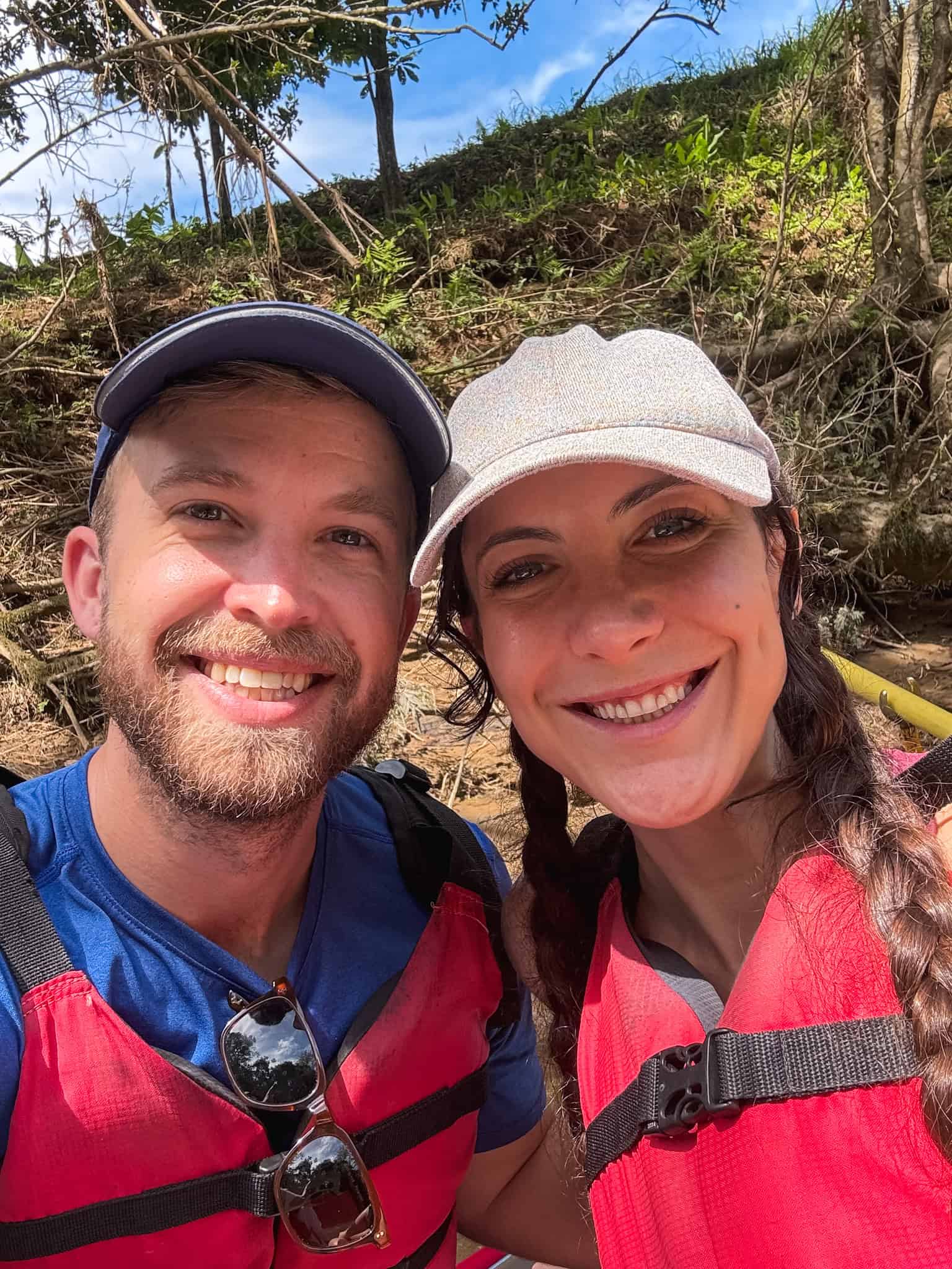 Couple wearing life vests taking selfie during safari float La Fortuna wildlife tour