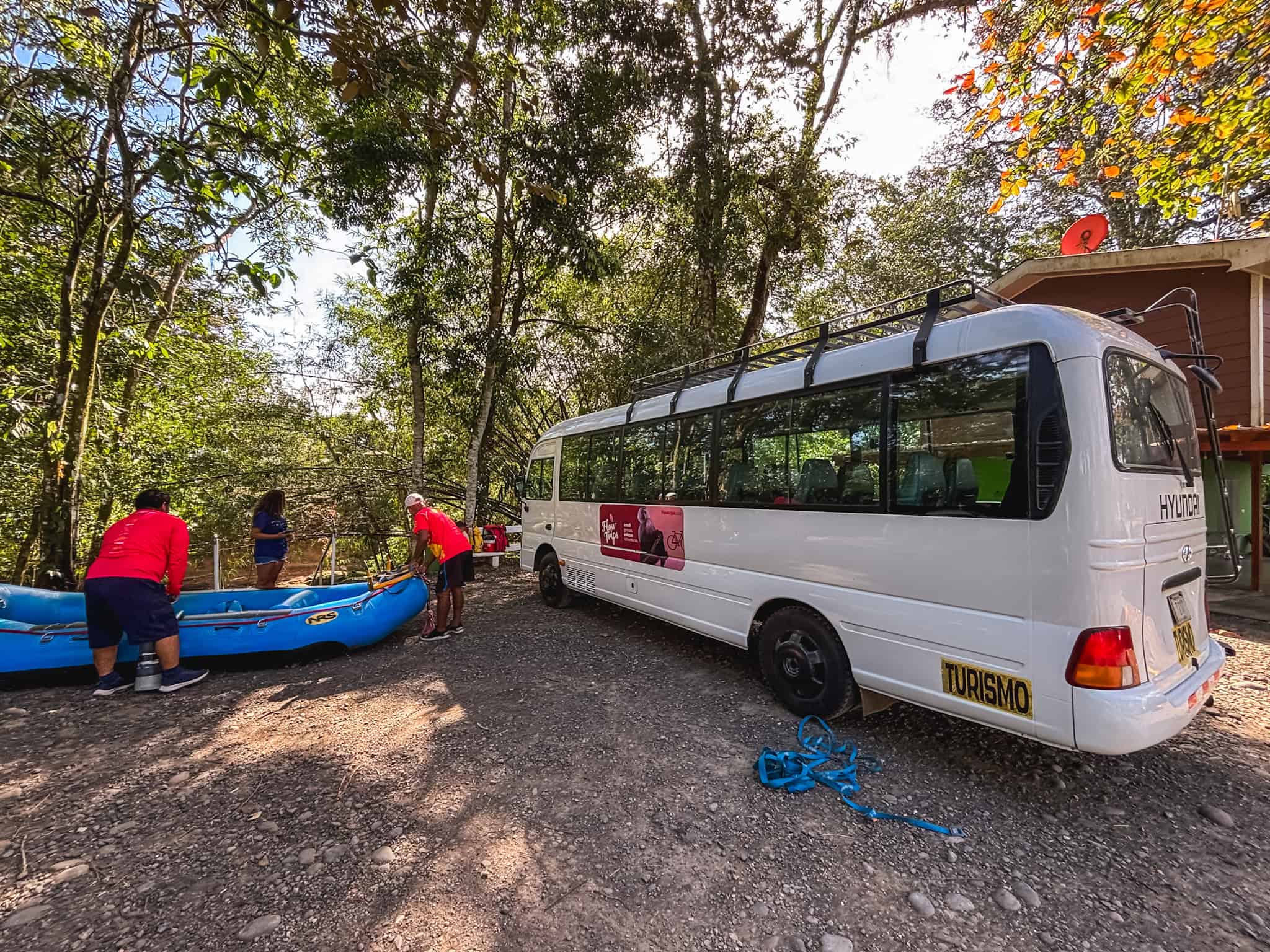 white tour bus with rafts for the safari float tour in costa rica
