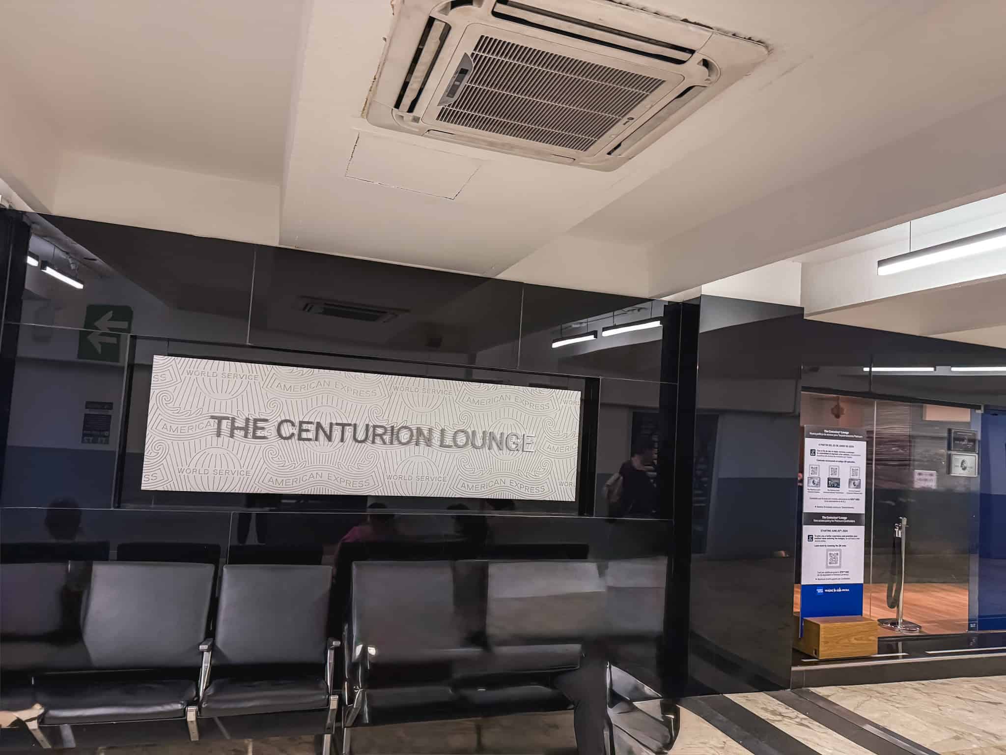 Entrance to the Centurion lounge Mexico City with black glass walls and white signage reading "THE CENTURION LOUNGE" at Terminal 1