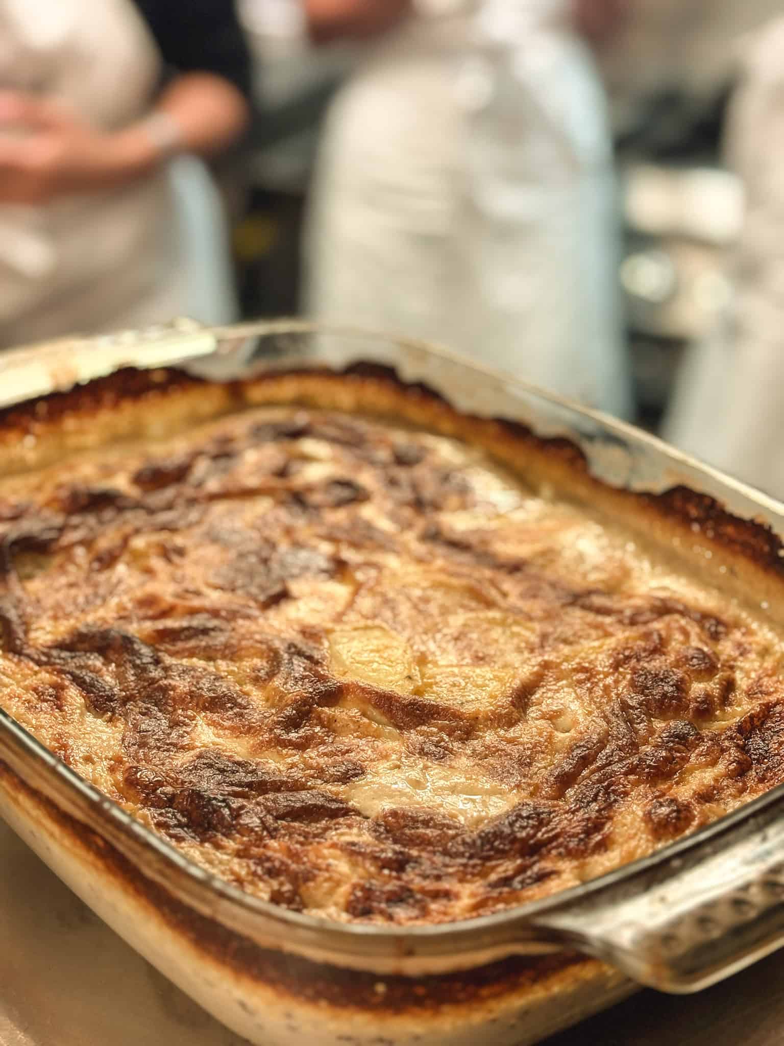 Golden potato gratin dauphinois fresh from oven at cooking class in Paris