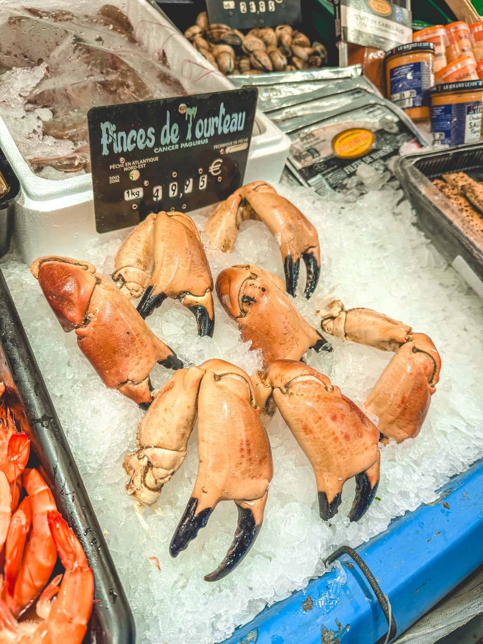 Crab claws (pinces de tourteau) on ice at traditional Paris fishmonger