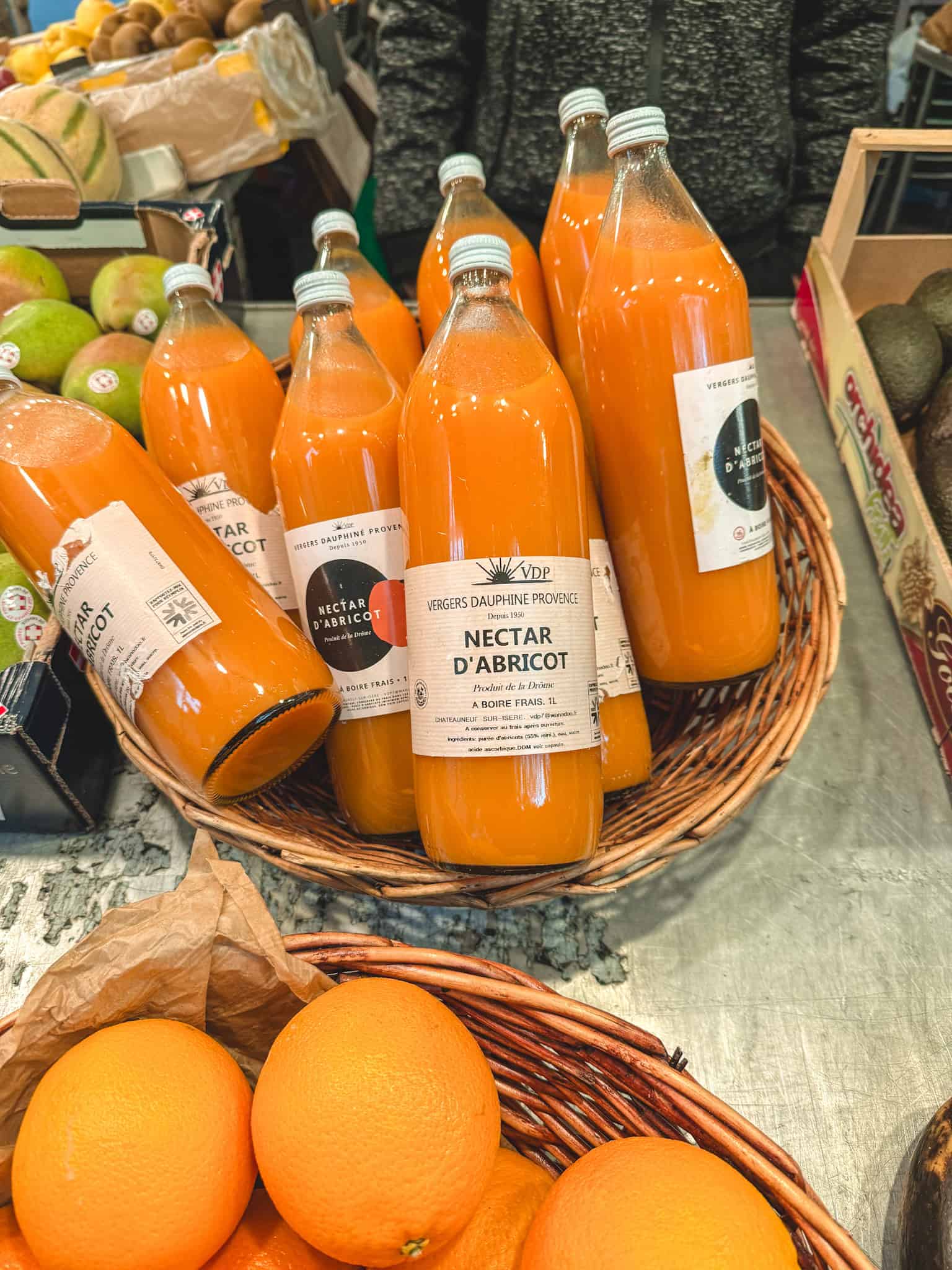 Bottles of French apricot nectar from Dauphine Provence at Paris farmers market