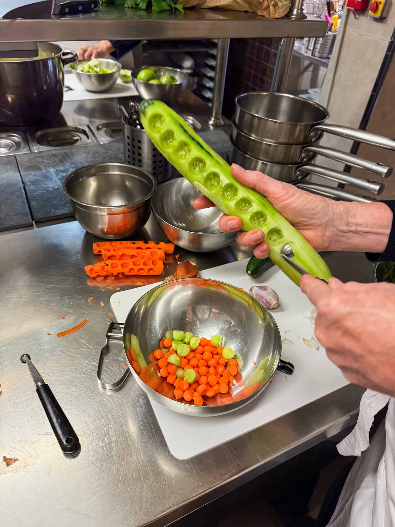 Preparing fresh vegetables for French cuisine during cooking class in Paris hands-on lesson