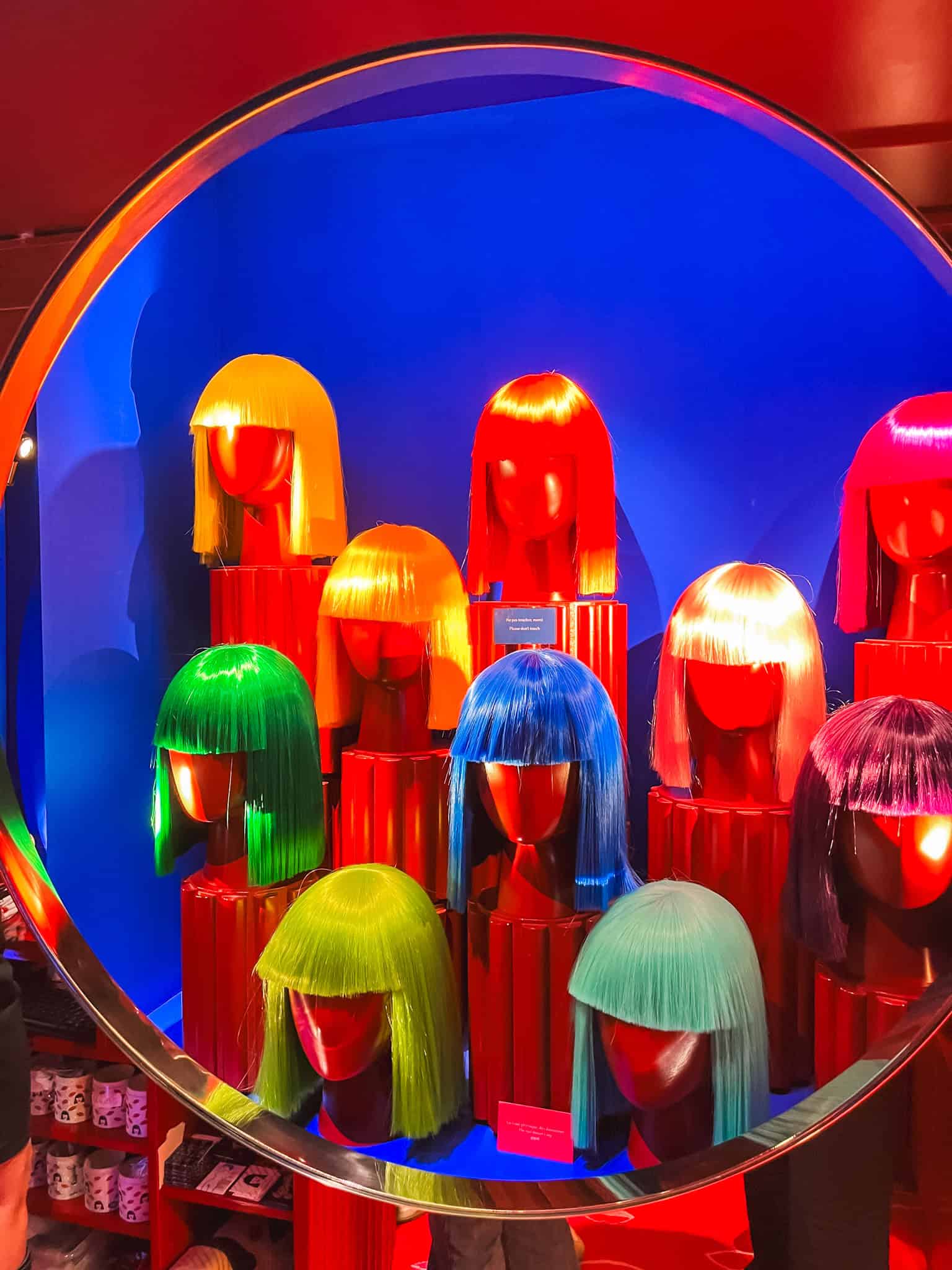 Vibrant wig display at crazy horse paris, representing unique things to do in Paris cultural experiences