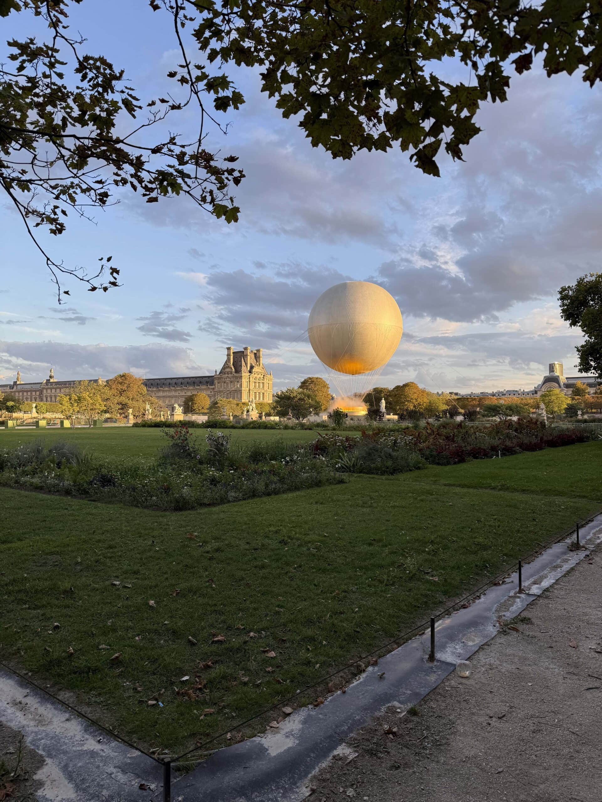 louvre gardens at sunset in paris with olympic flame