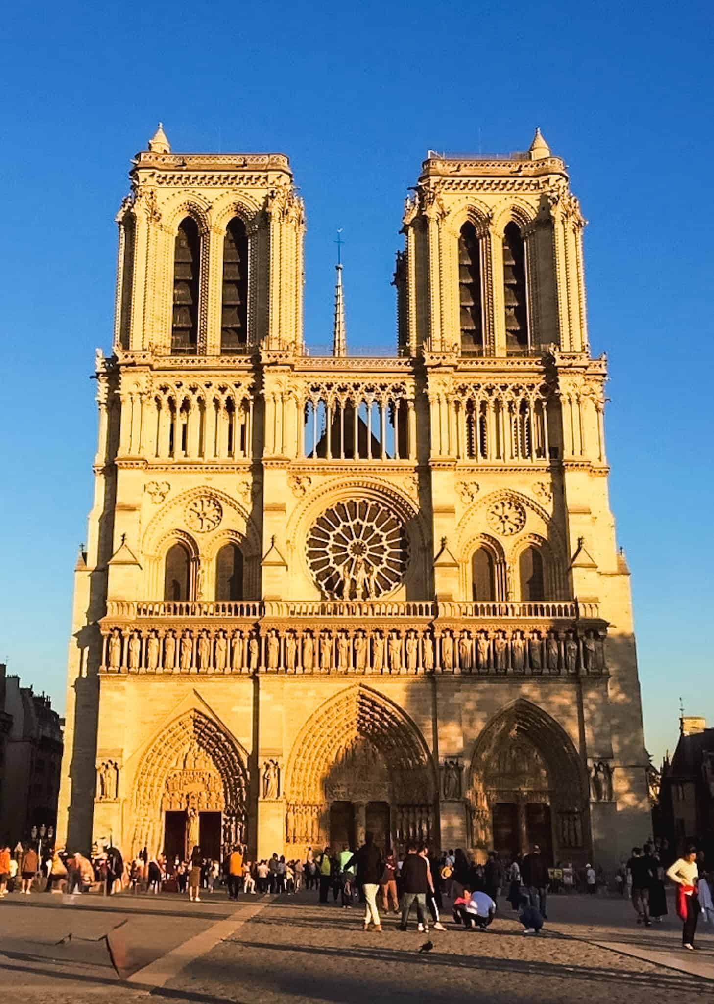Notre-Dame Cathedral illuminated in golden evening light, one of the must see things in Paris architectural landmarks