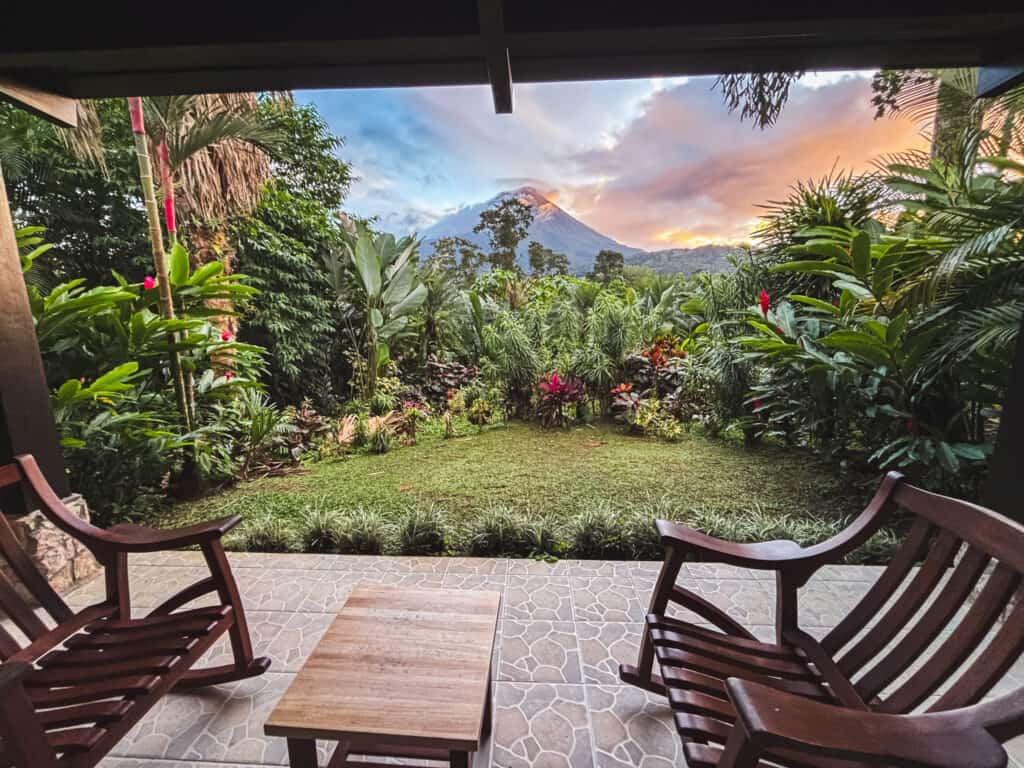 Sunset Arenal Volcano view from hotel terrace with tropical gardens, scenic accommodation for where to stay in La Fortuna with volcano views
