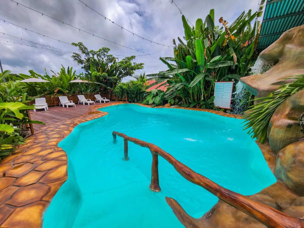 Cabanas del Rio tropical pool area surrounded by lush gardens, budget-friendly option for where to stay in La Fortuna Costa Rica