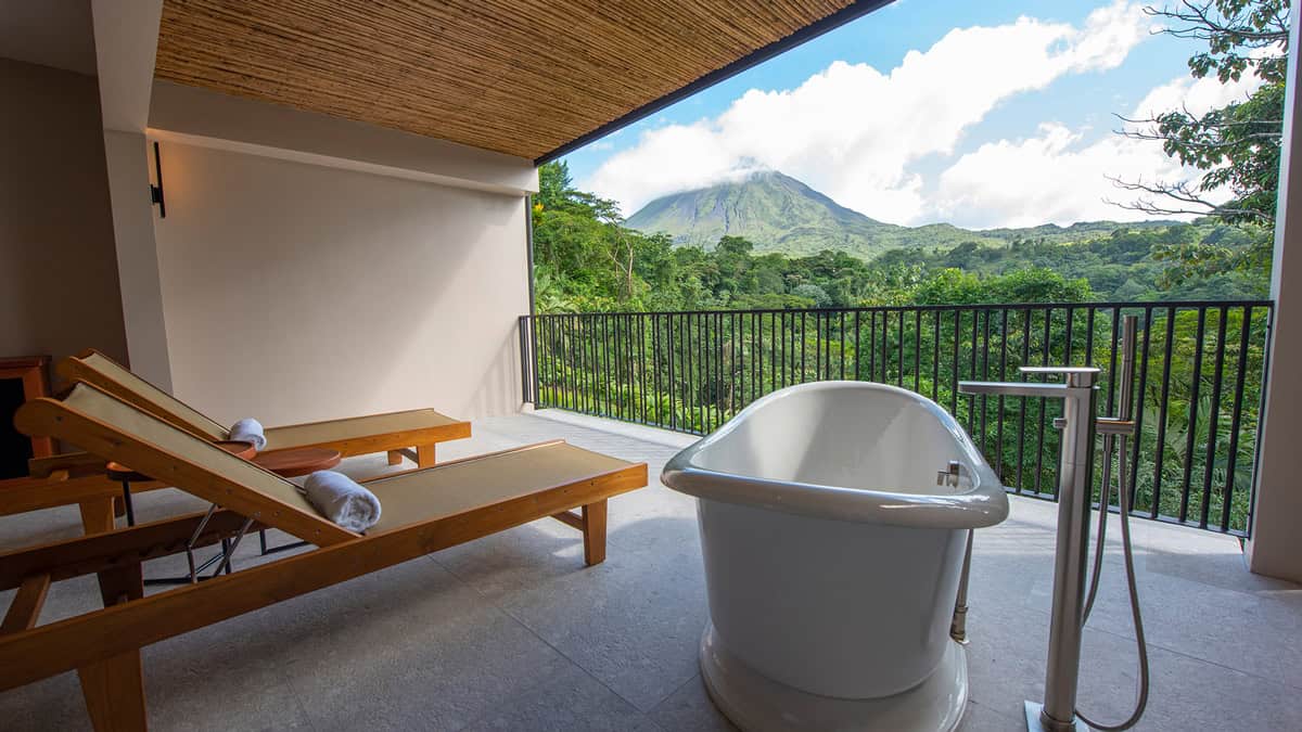 Tabacon Thermal Resort balcony with Arenal Volcano view and outdoor soaking tub, luxury accommodation for where to stay in La Fortuna with volcano views