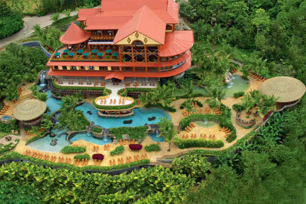 The Springs Resort aerial view showing luxury pools and distinctive red roofing, premium option for where to stay in La Fortuna with hot springs