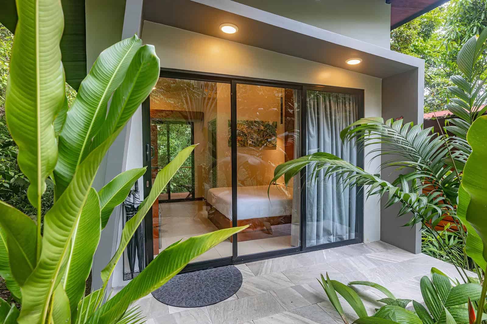 Tifakara Boutique Hotel contemporary suite with floor-to-ceiling rainforest views, unique boutique choice for where to stay in La Fortuna