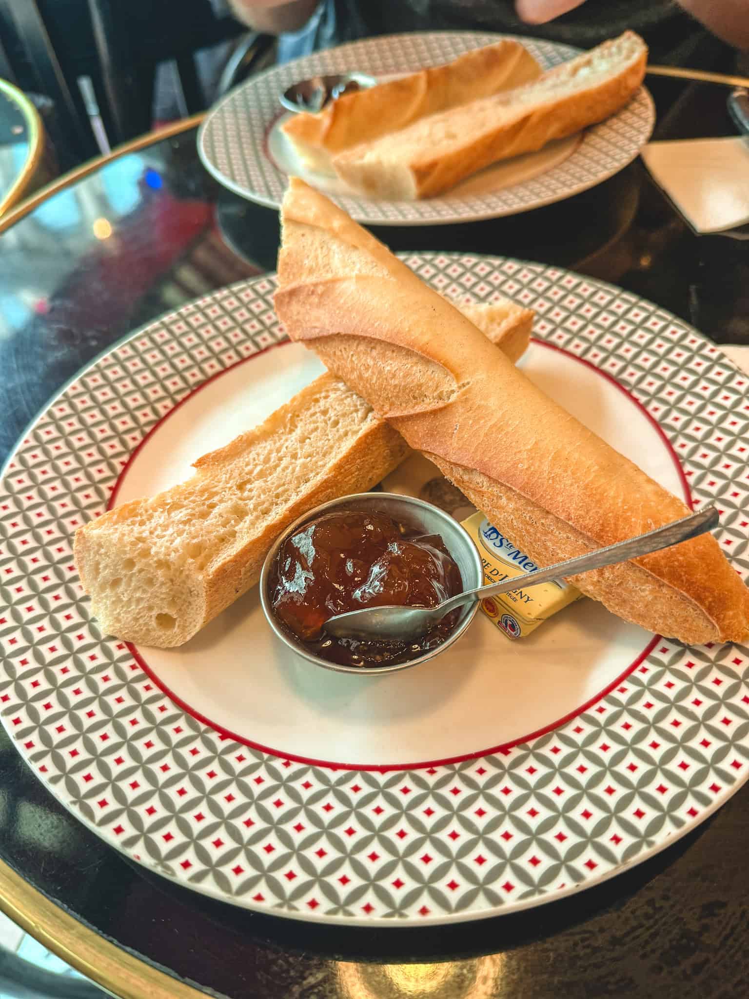 Fresh French baguette with butter and jam at a Parisian cafe - enjoying Paris during a strike