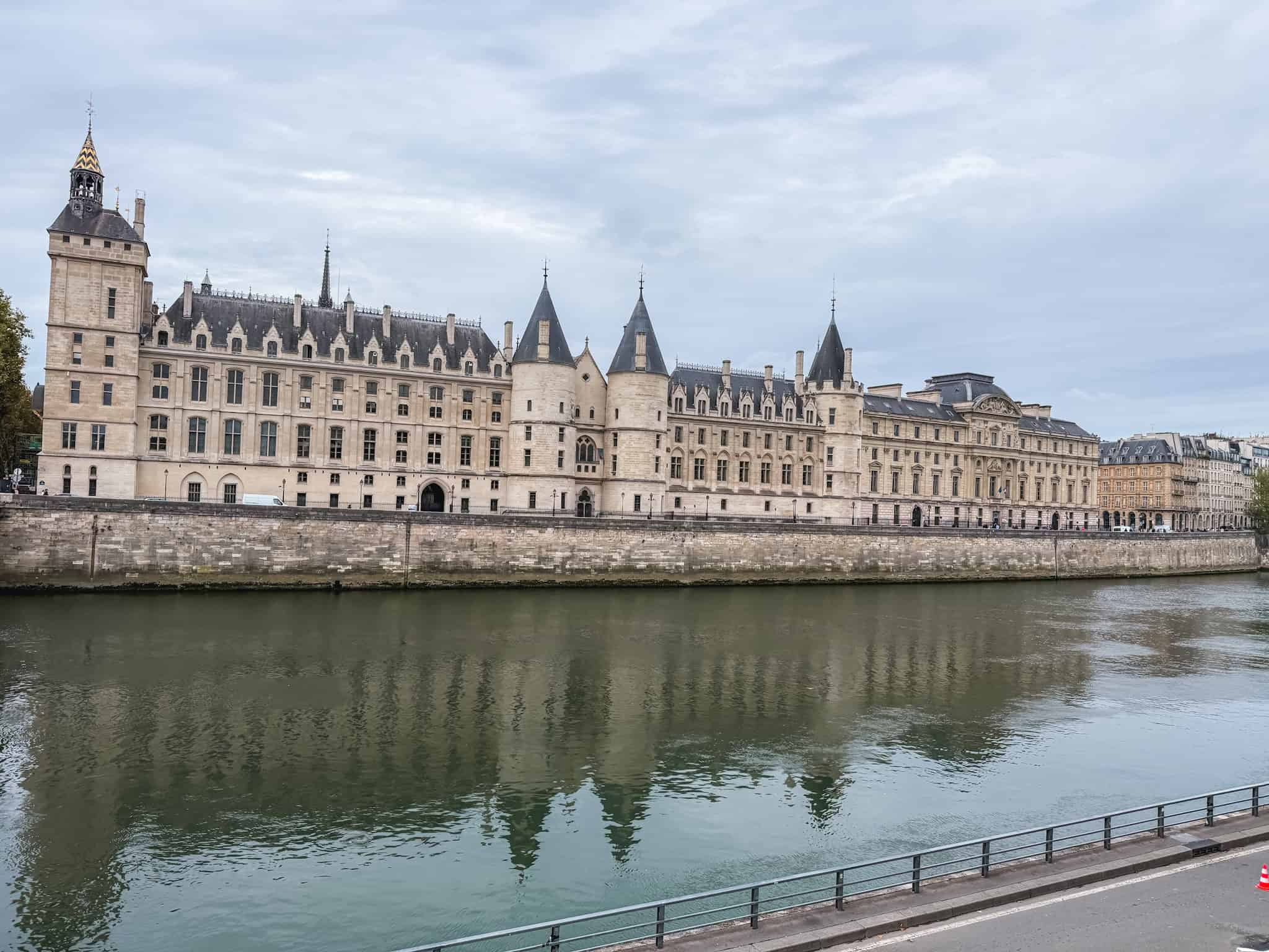 Conciergerie palace and the Seine River in Paris on a cloudy day - walking alternative during metro strikes