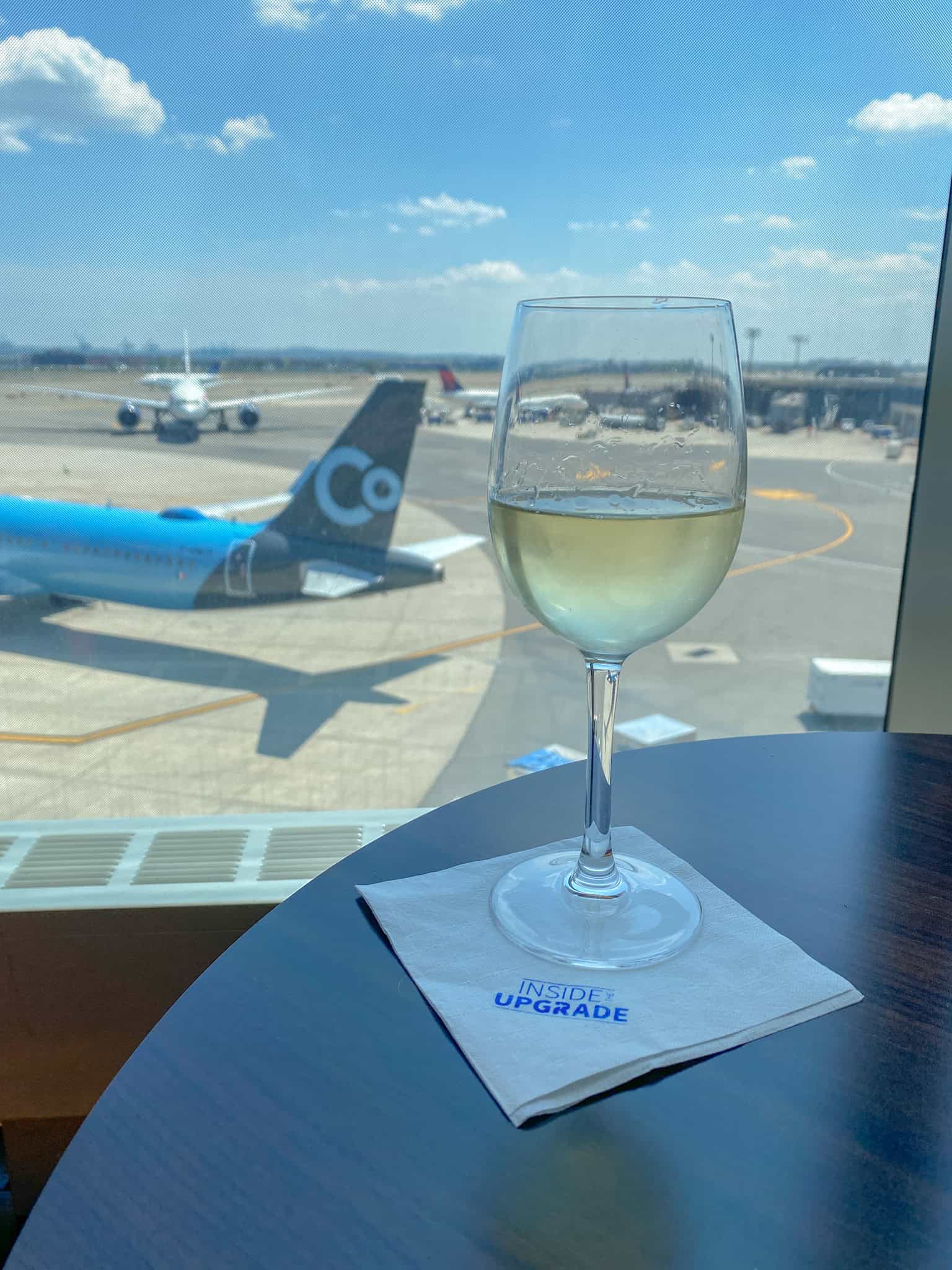 wine glass at airport lounge from inside the upgrade