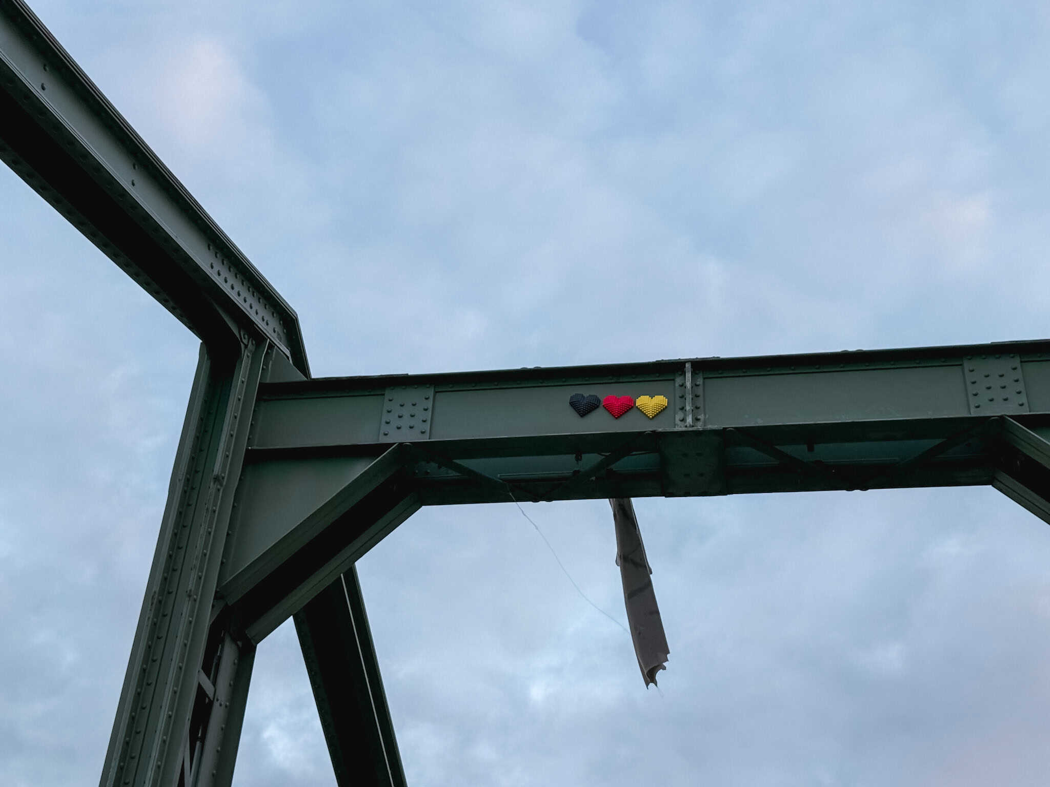 Heart-shaped installation in German flag colors on Frankfurt bridge, charming detail for one day in Frankfurt