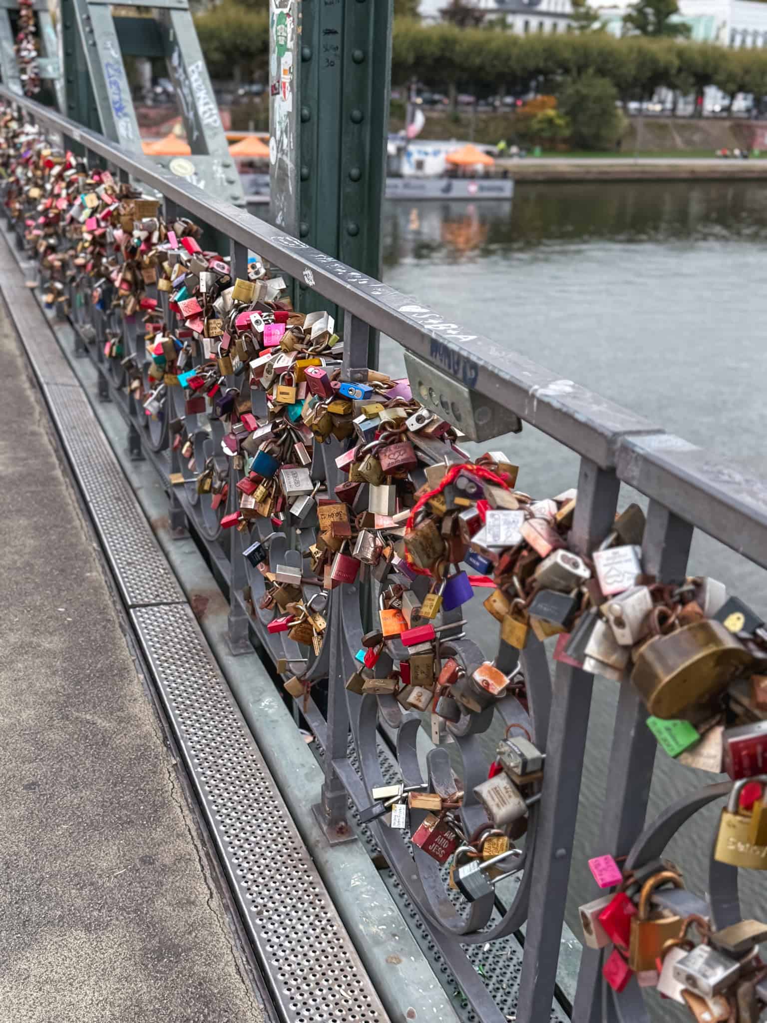 Love locks adorning the Eiserner Steg bridge over the Main River, romantic spot during one day in Frankfurt