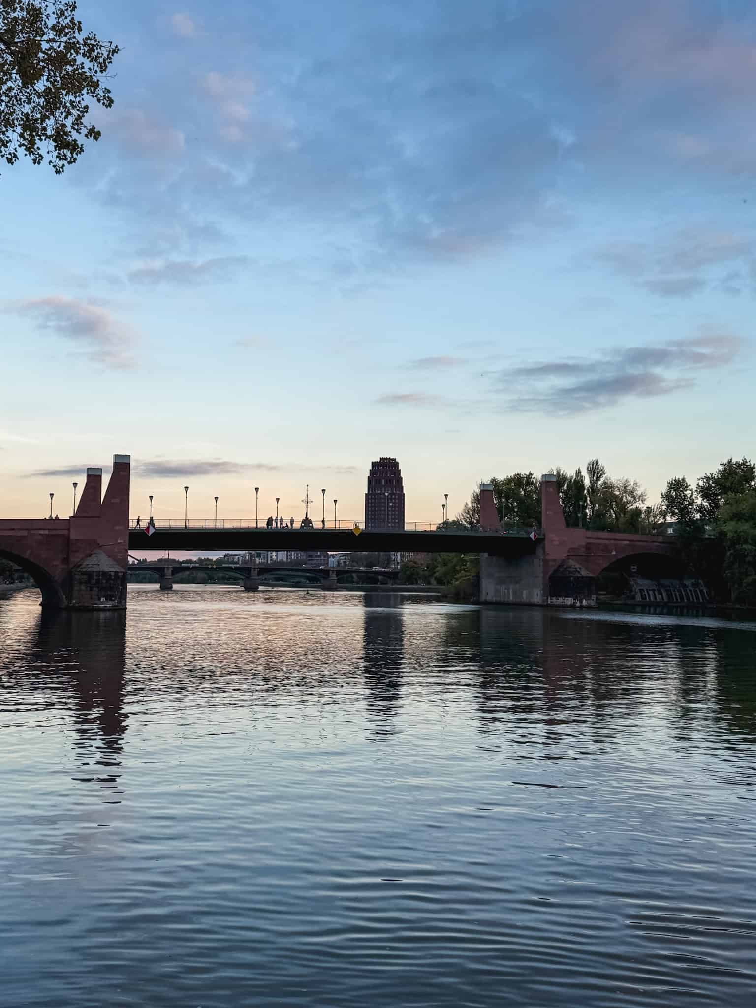 Sunset over the Main River bridges with Frankfurt skyline, beautiful evening views for a layover in Frankfurt