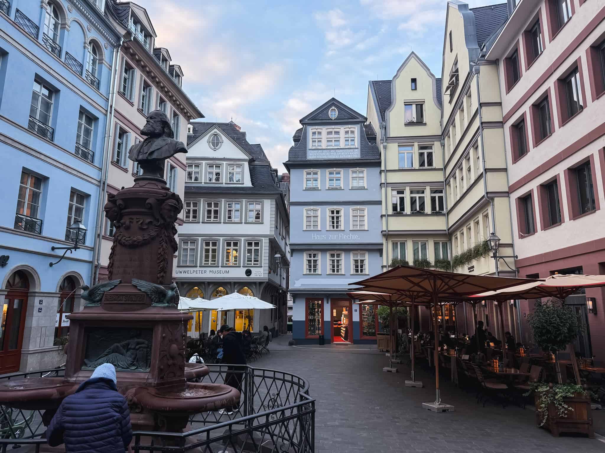 Charming old town square with historic fountain and colorful facades, picturesque setting for one day in Frankfurt