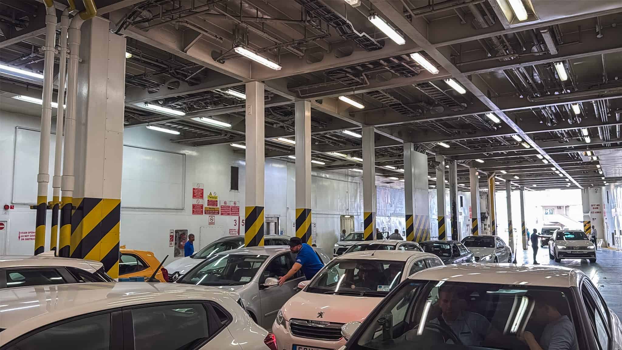 Car ferry deck loaded with vehicles for renting a car in Malta and taking it between the islands of Malta and Gozo