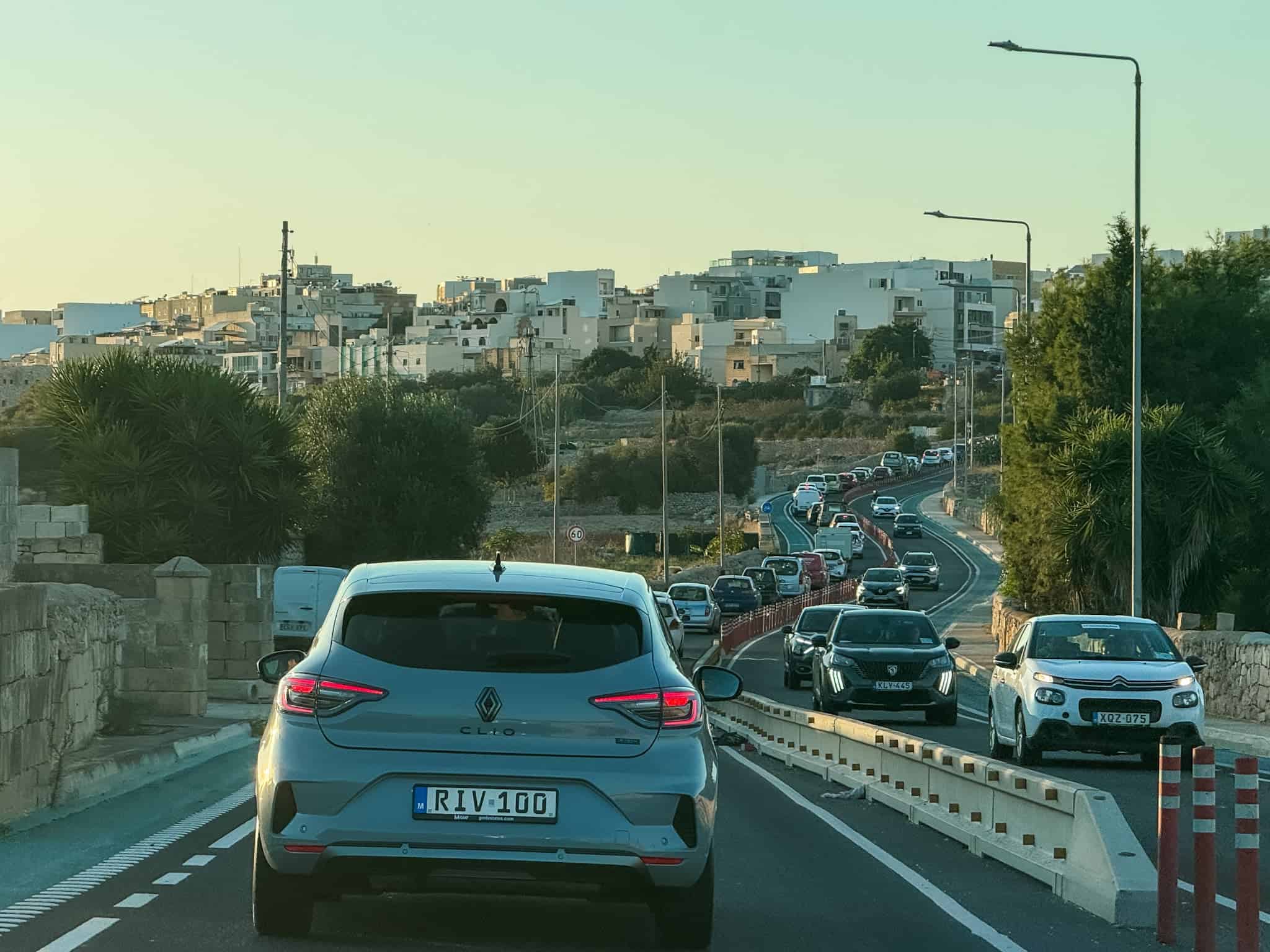 Traffic congestion on Malta roads showing typical driving in Malta conditions during peak hours near residential areas