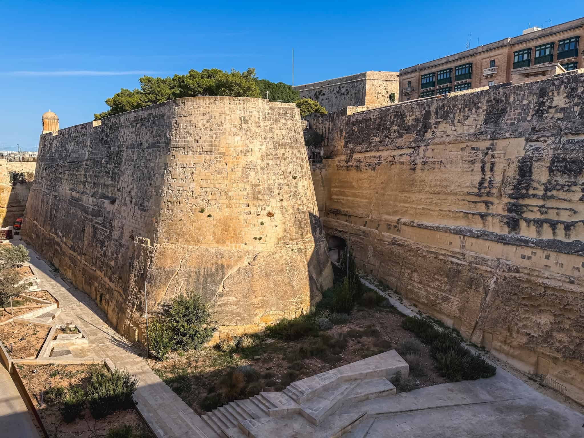 Historic limestone fortification walls and bastions surrounding Valletta, Malta's UNESCO World Heritage capital city accessible by car