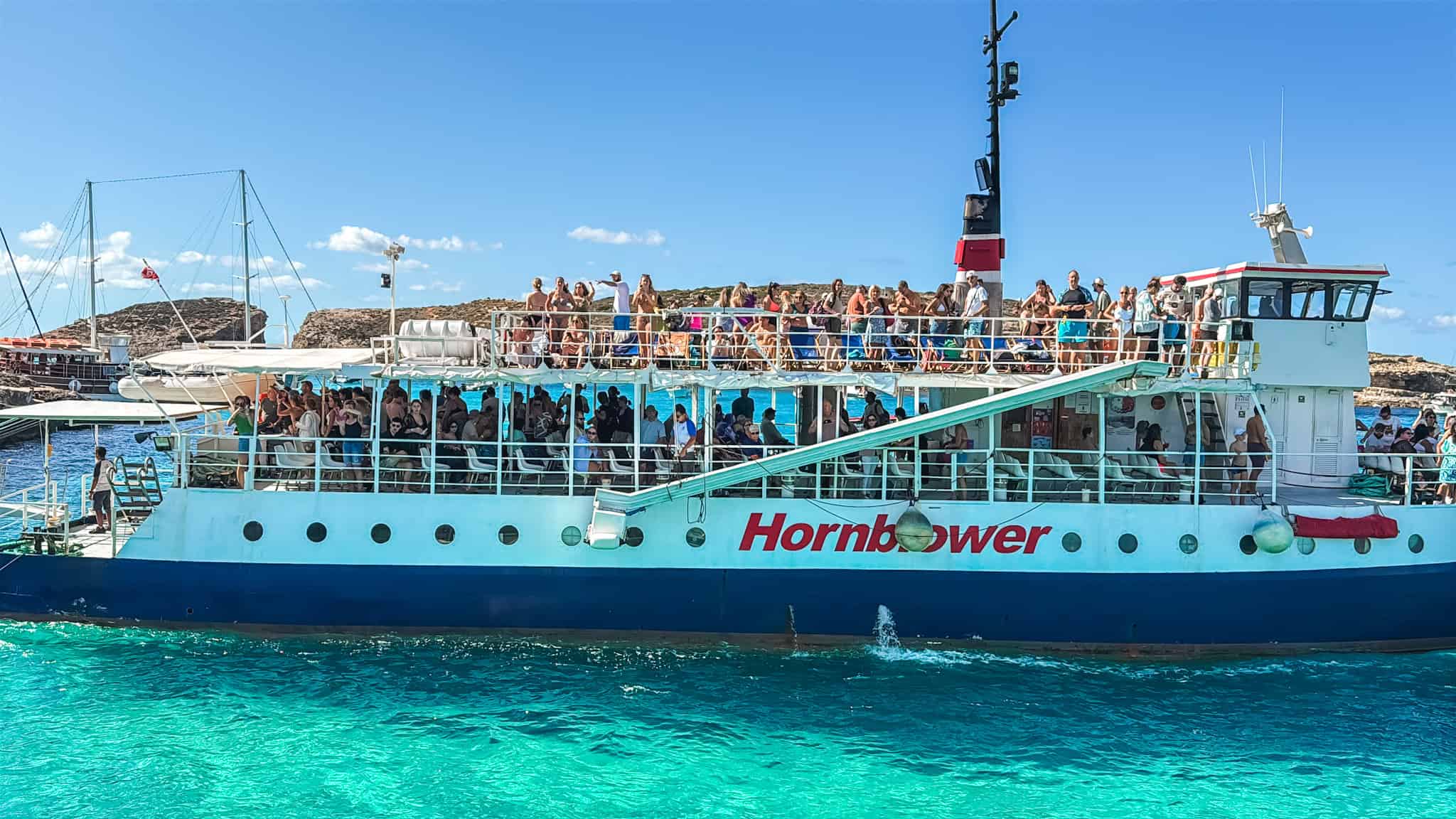 Popular Malta boat tours ferry to the Blue Lagoon and Comino with large passenger groups
