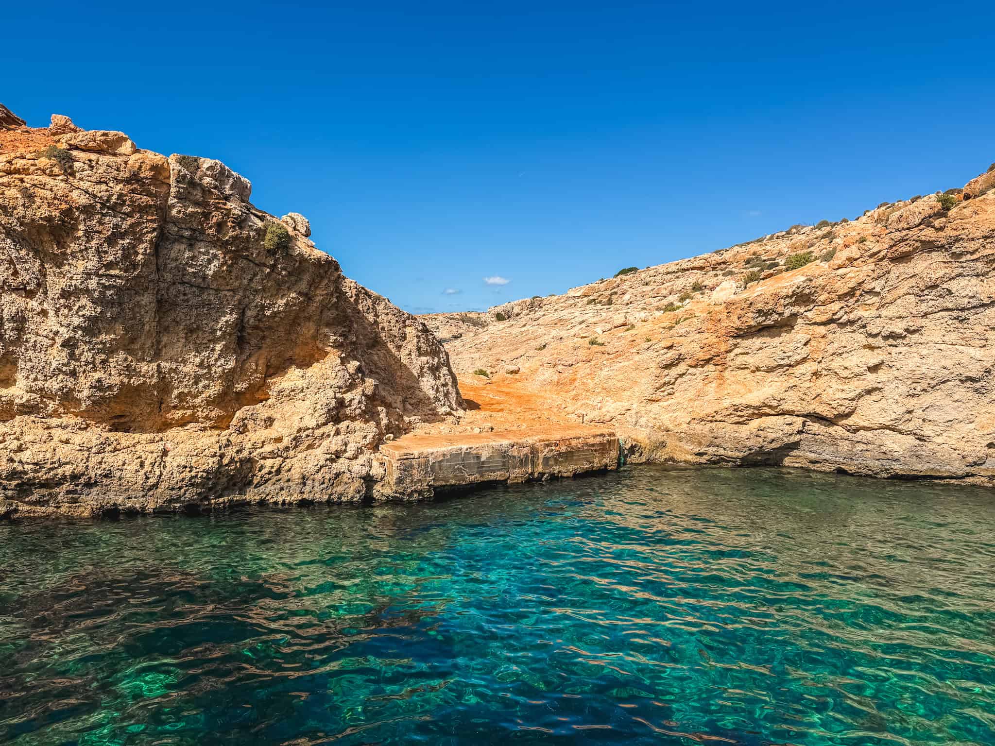 Crystal Lagoon limestone cliffs and emerald waters near Comino on Malta boat excursions