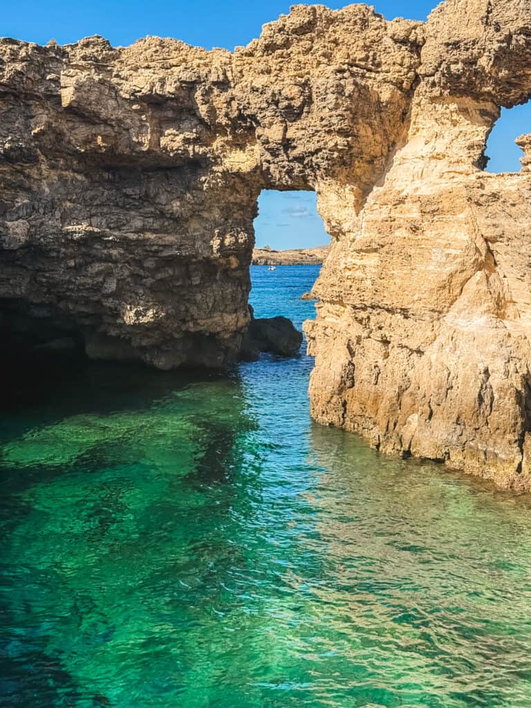 Stunning rock formations with emerald water at the Crystal Lagoon on Comino