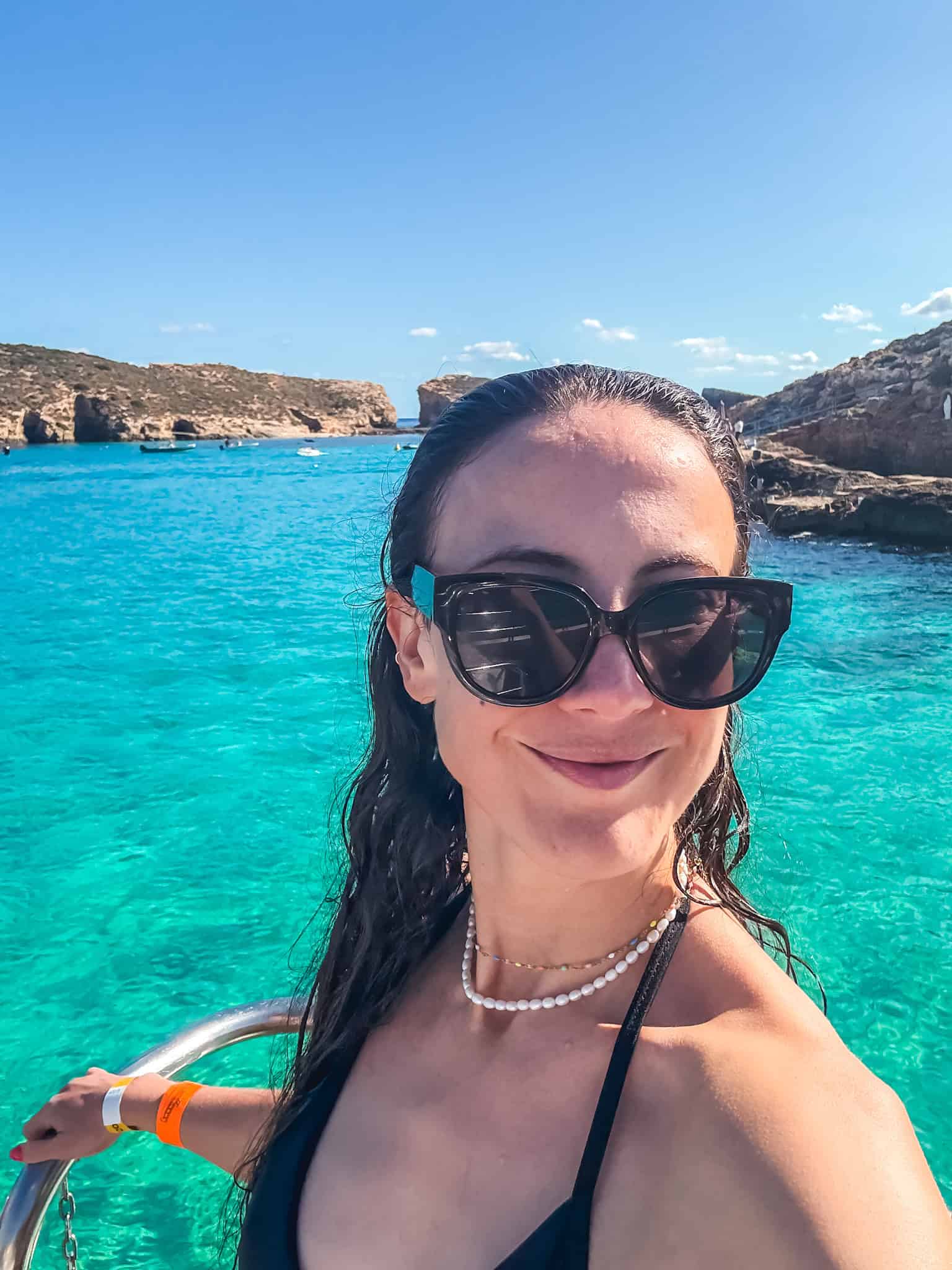 woman Enjoying the Blue Lagoon crystal waters on a Comino day trip from Malta