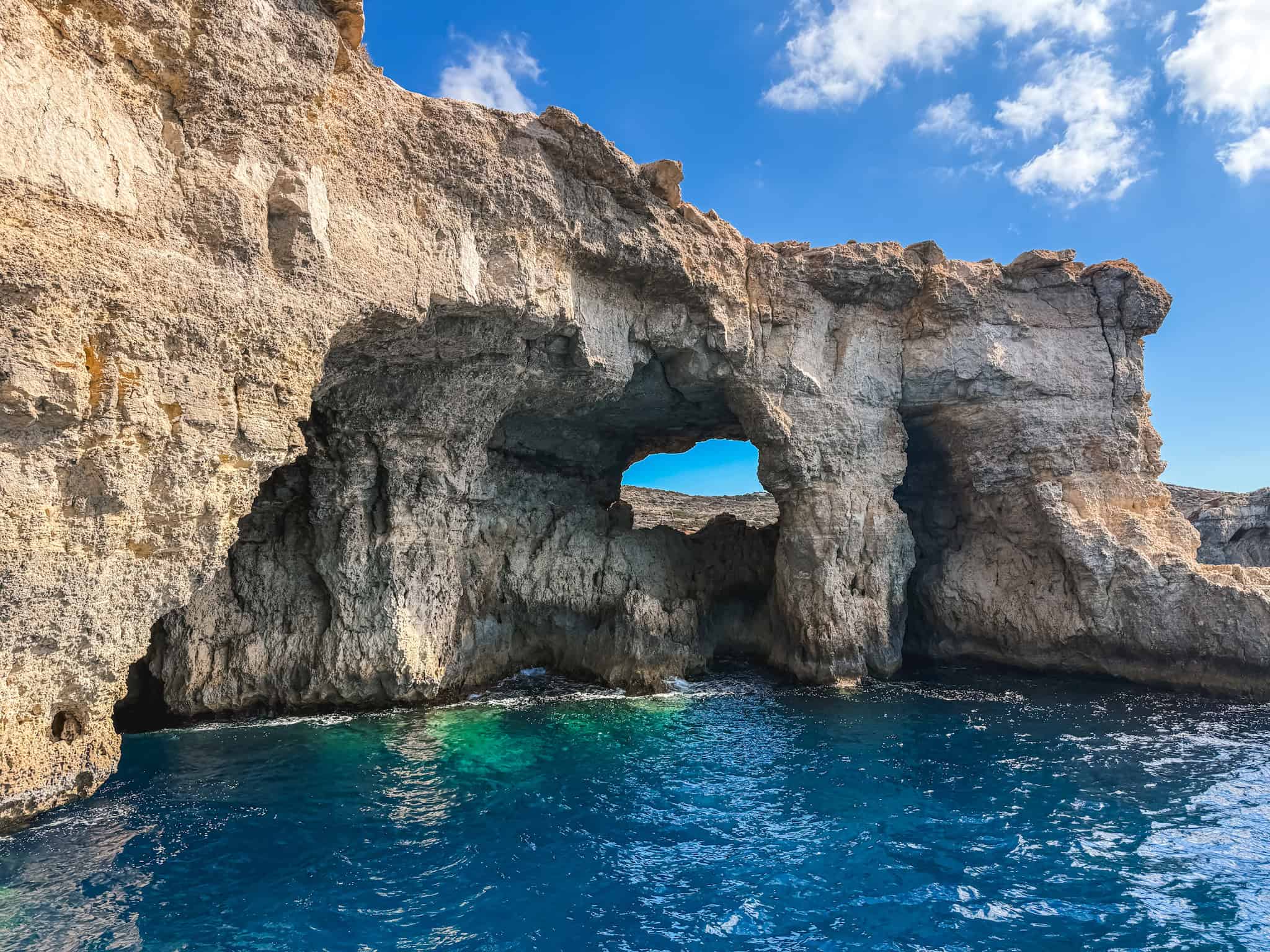 Natural rock arch and sea caves visited during Malta boat tours to Comino