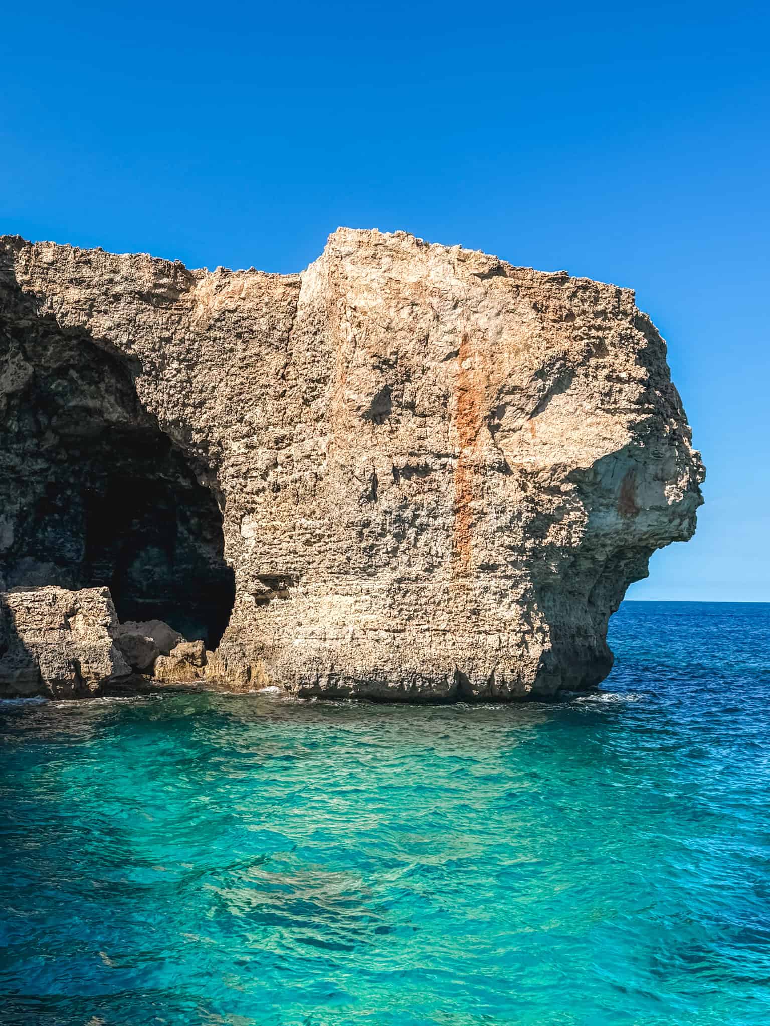 Limestone cliffs and turquoise Mediterranean waters at Malta sea caves