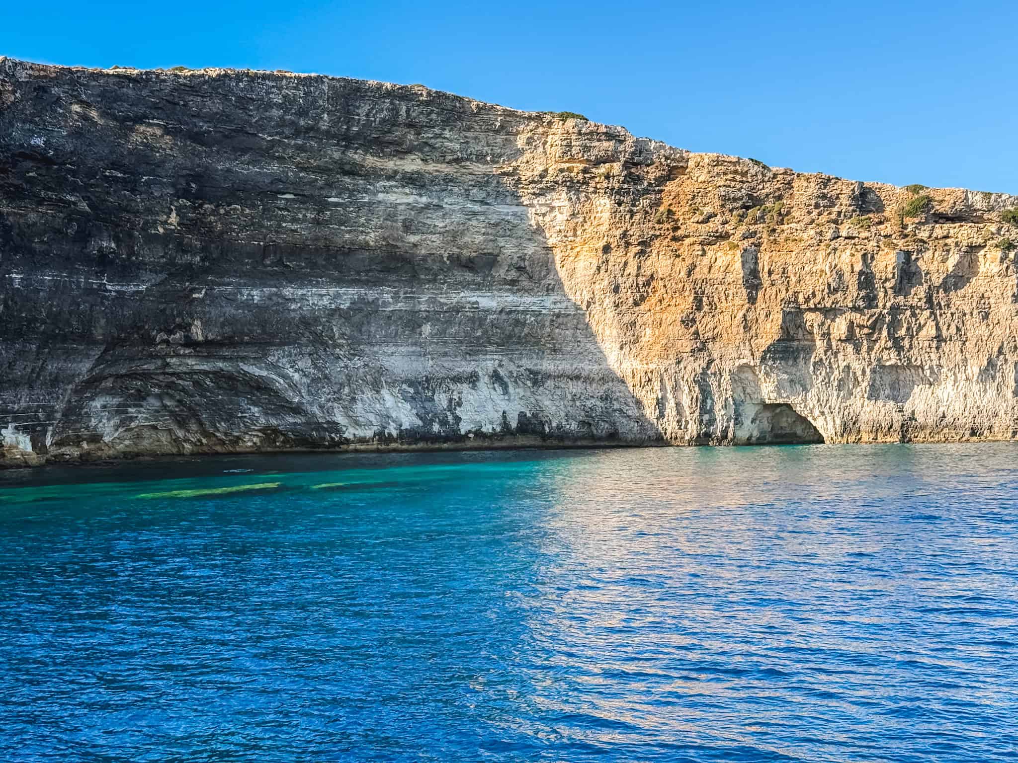 Dramatic limestone rock formations along Malta coastline near the Blue Lagoon